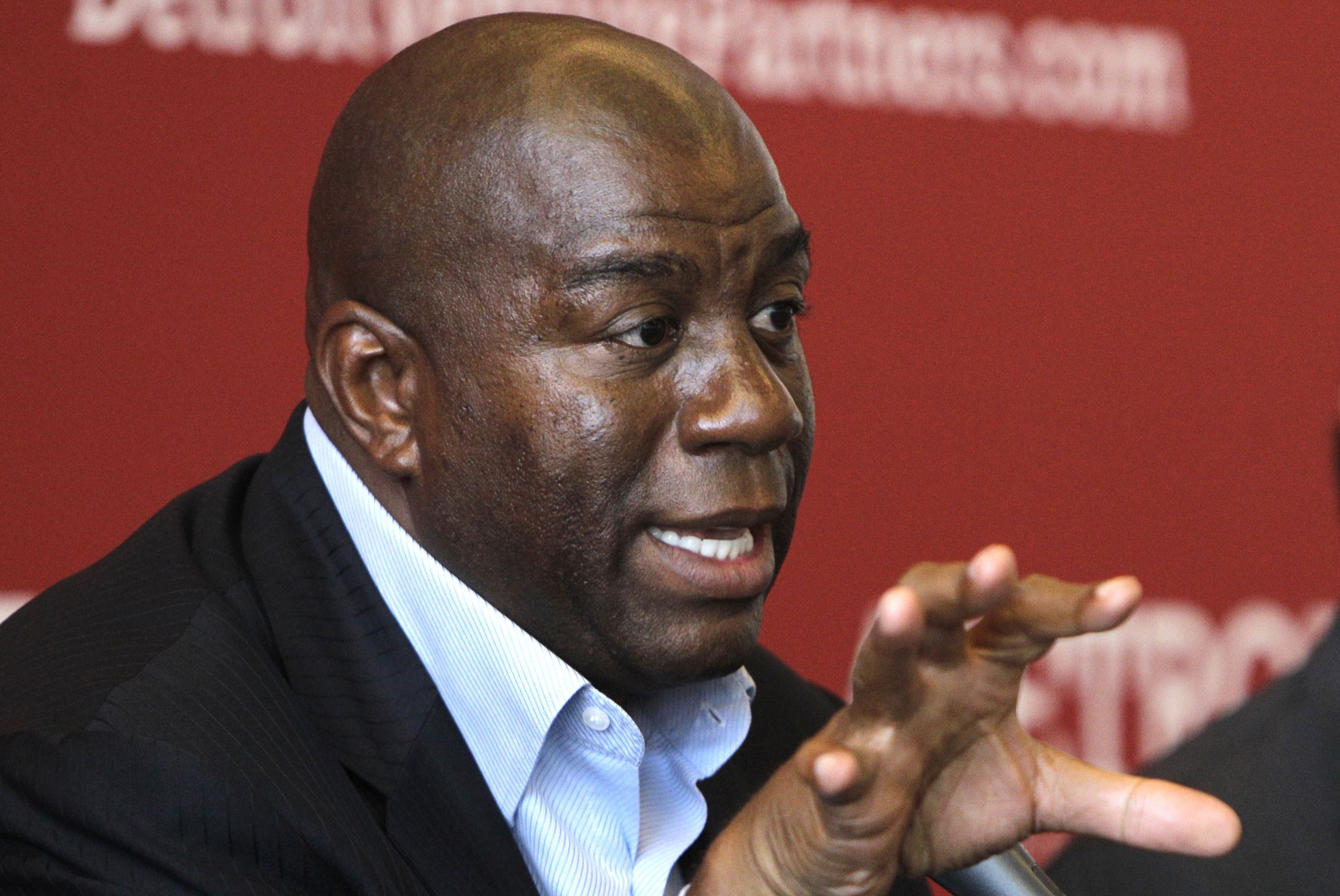 FILE- In a July 21, 2011 file photo, Hall-of-Fame basketball player turned businessman Earvin