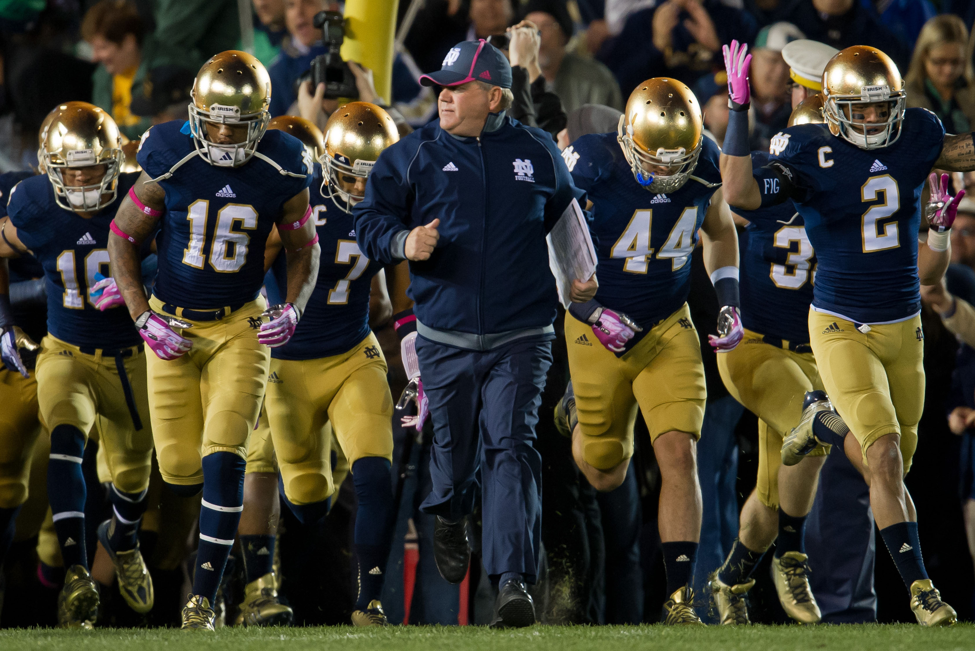 Oct 19, 2013; South Bend, IN, USA; Notre Dame Fighting Irish head coach Brian Kelly runs onto the field with his team prior the game against the USC Trojans at Notre Dame Stadium. Notre Dame won 14-10. Mandatory Credit: Matt Cashore-USA TODAY Sports