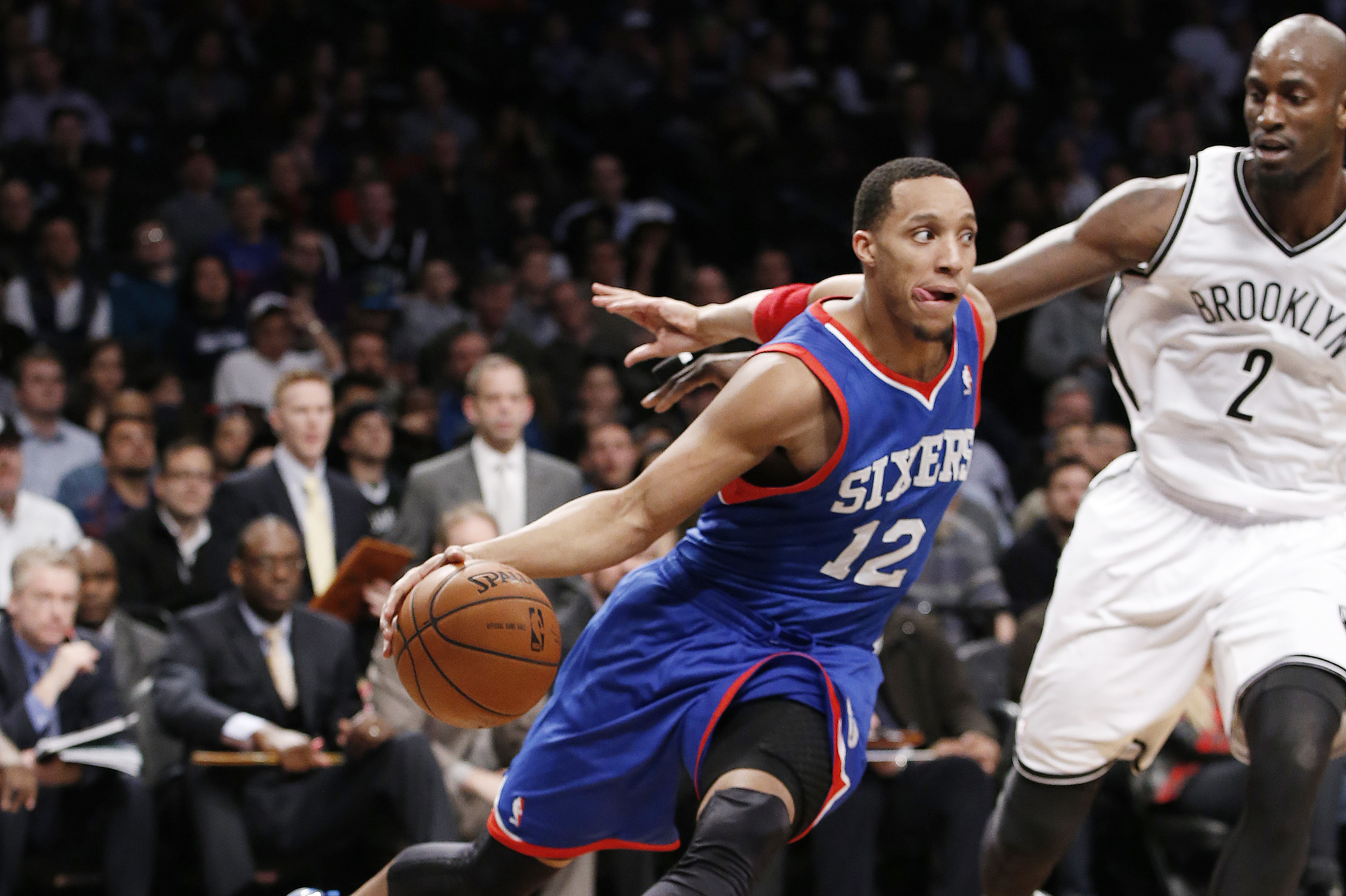 Brooklyn Nets forward Kevin Garnett (2) defends Philadelphia 76ers forward Evan Turner (12) in the second half of their NBA basketball game at the Barclays Center, Monday, Feb. 3, 2014 in New York. The Nets defeated the Sixers 108-102. (AP Photo/Kathy Willens)