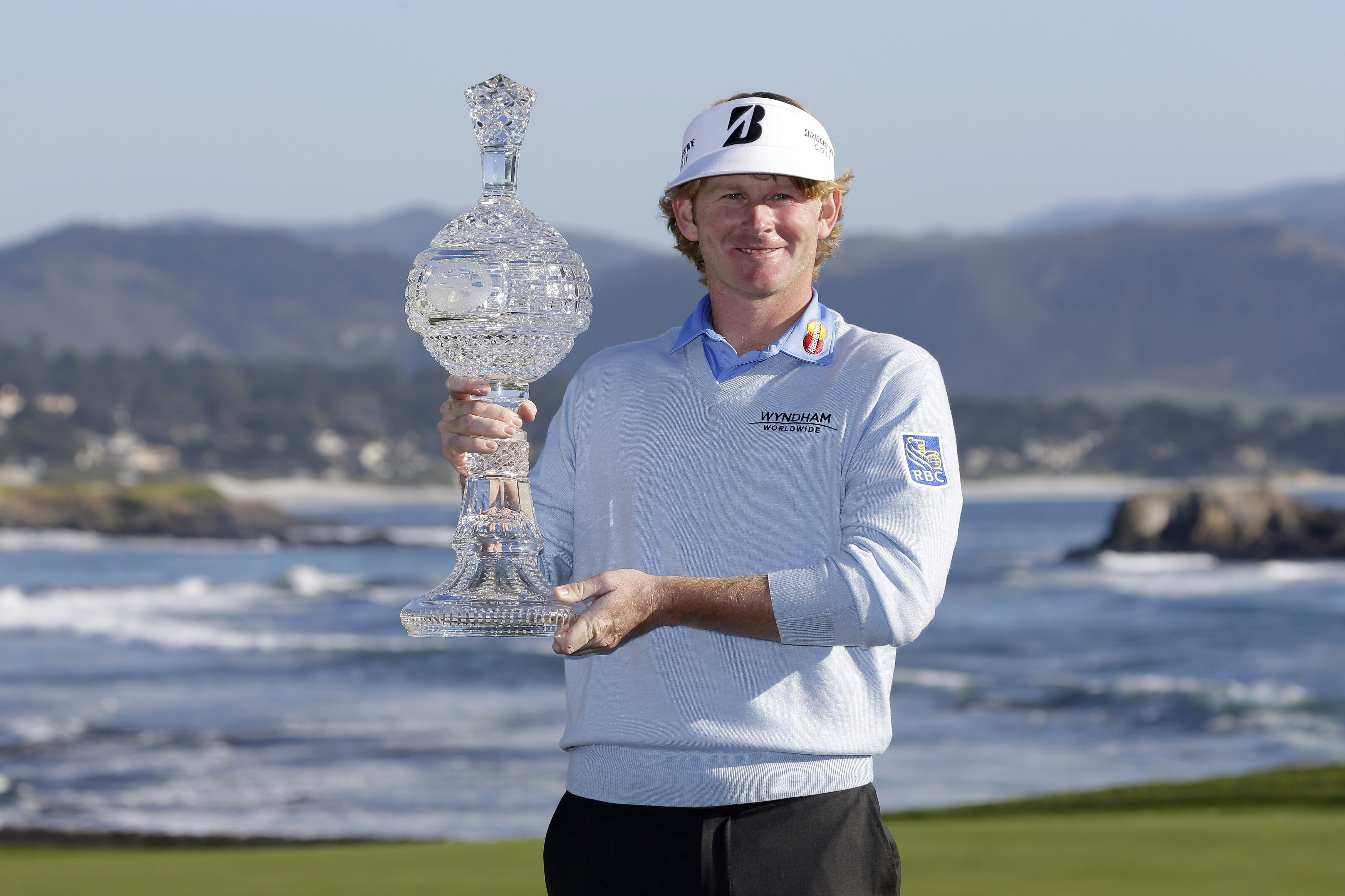 Brandt Snedeker poses with his trophy on the 18th green of the Pebble Beach Golf Links after winning the AT&T Pebble Beach Pro-Am golf tournament Sunday, Feb. 10, 2013, in Pebble Beach, Calif. Snedeker won the tournament after shooting a 7-under-par 65 to finish at total 19-under-par. (AP Photo/Eric Risberg)