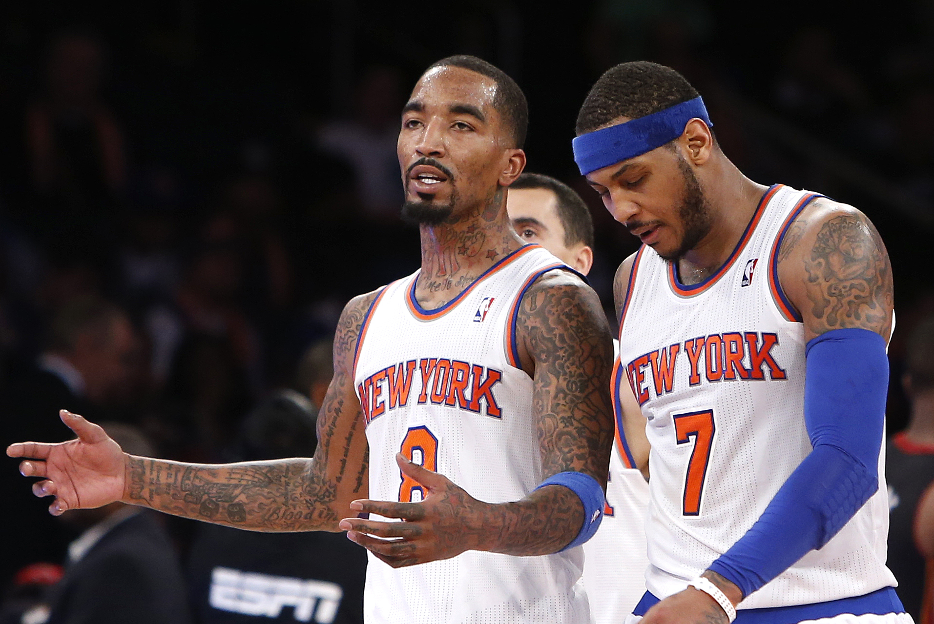 New York Knicks' J.R. Smith (8) talks with teammate Carmelo Anthony (7) as they walk off the court during a timeout late in the fourth quarter of an NBA basketball game against the Miami Heat, Saturday, Feb. 1, 2014, in New York. Miami won 106-91. (AP Photo/Jason DeCrow)