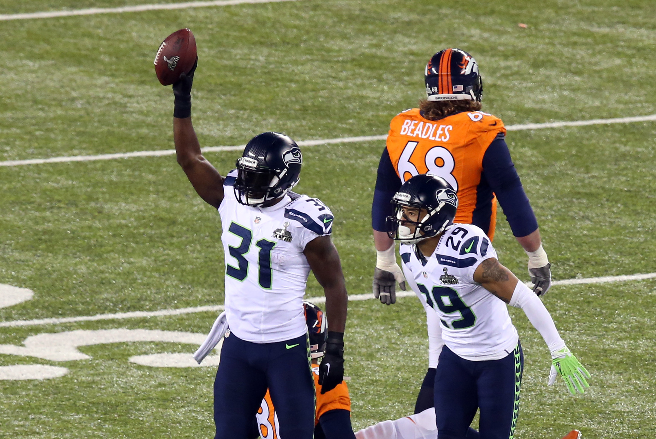 Feb 2, 2014; East Rutherford, NJ, USA; Seattle Seahawks strong safety Kam Chancellor (31) celebrates his interception against the Denver Broncos during the first half in Super Bowl XLVIII at MetLife Stadium.  Mandatory Credit: Noah K. Murray-USA TODAY Sports