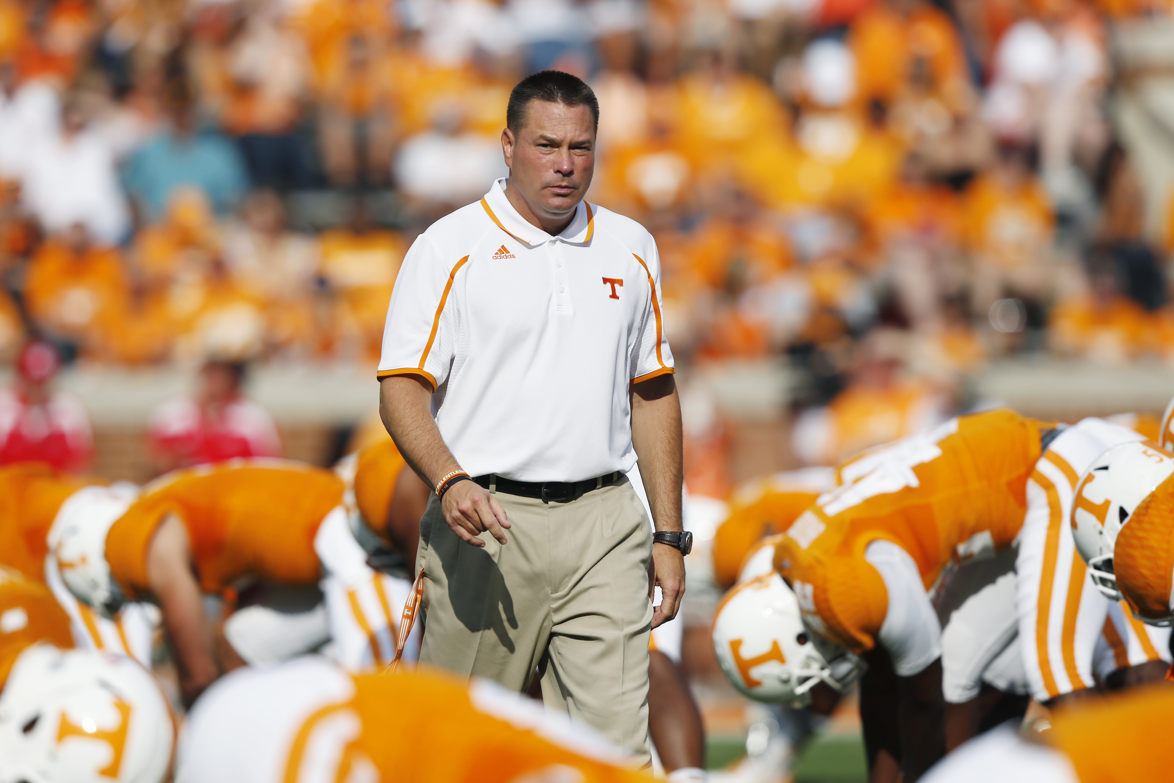 Tennessee's head coach Butch Jones walks through players during warm-ups before an NCAA college football game against Austin Peay on Saturday, Aug. 31, 2013 in Knoxville, Tenn. (AP Photo/Wade Payne)