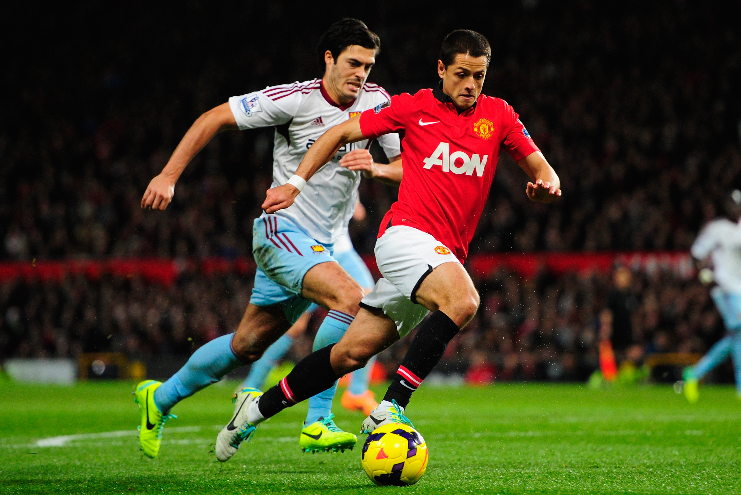 MANCHESTER, ENGLAND - DECEMBER 21:  Javier Hernandez of Manchester United competes with James Tomkins of West Ham United during the Barclays Premier League match between Manchester United and West Ham United at Old Trafford on December 21, 2013 in Manchester, England.  (Photo by Stu Forster/Getty Images)