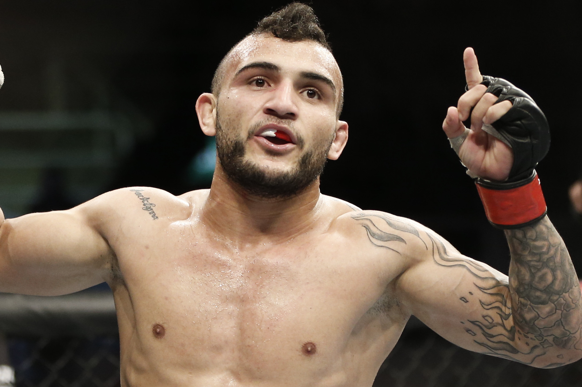 John Lineker, from Brazil, celebrates after defeating countryman Jose Maria, during their UFC 163 mixed martial arts Flyweight bout in Rio de Janeiro, Brazil, Saturday, Aug. 3, 2013. (AP Photo/Felipe Dana)