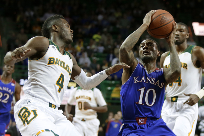 Baylor's Gary Franklin (4) defends as Kansas' Naadir Tharpe (10) drives to the basket for a shot attempt in the first half of an NCAA college basketball game, Tuesday, Feb. 4, 2014, in Waco, Texas. (AP Photo/Tony Gutierrez)