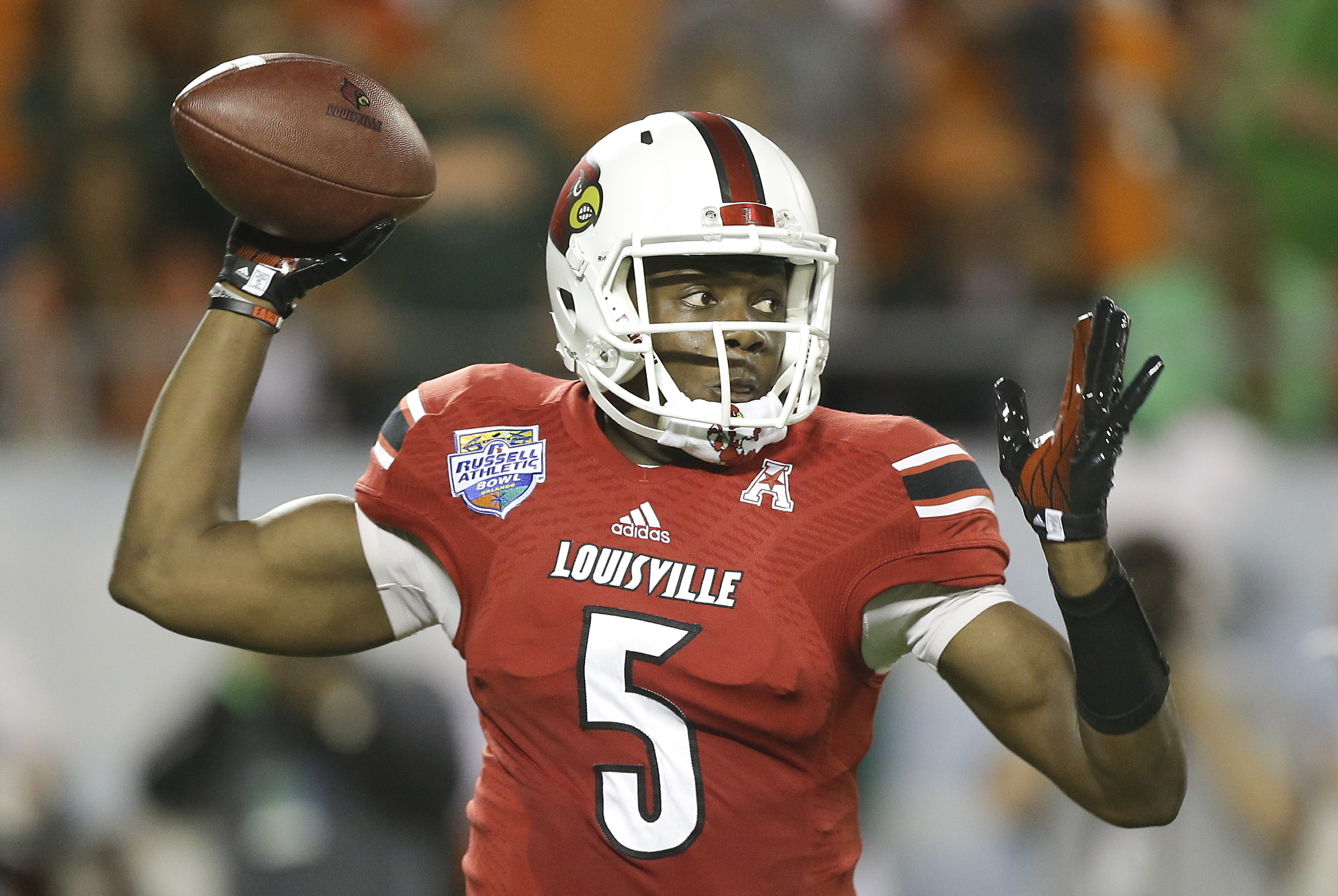 Louisville quarterback Teddy Bridgewater throws a pass during the first half of the Russell Athletic Bowl NCAA college football game against Miami in Orlando, Fla., Saturday, Dec. 28, 2013.(AP Photo/John Raoux)