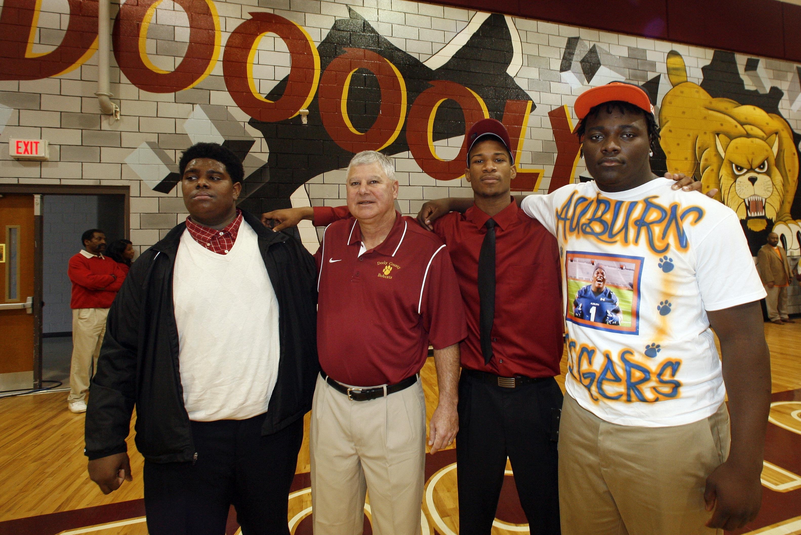 Feb 6, 2013; Vienna, GA USA; Mississippi Delta Community College signee JaSean Wiley and Dooly County High School football coach Jimmy Hughes and Troy signee Jaylen Daniels and defensive tackle Montravius Adams pose for a photo after Adams made his decision to attend Auburn during National Signing Day at Dooly County High School. Mandatory Credit: Phil Sears-USA TODAY Sports