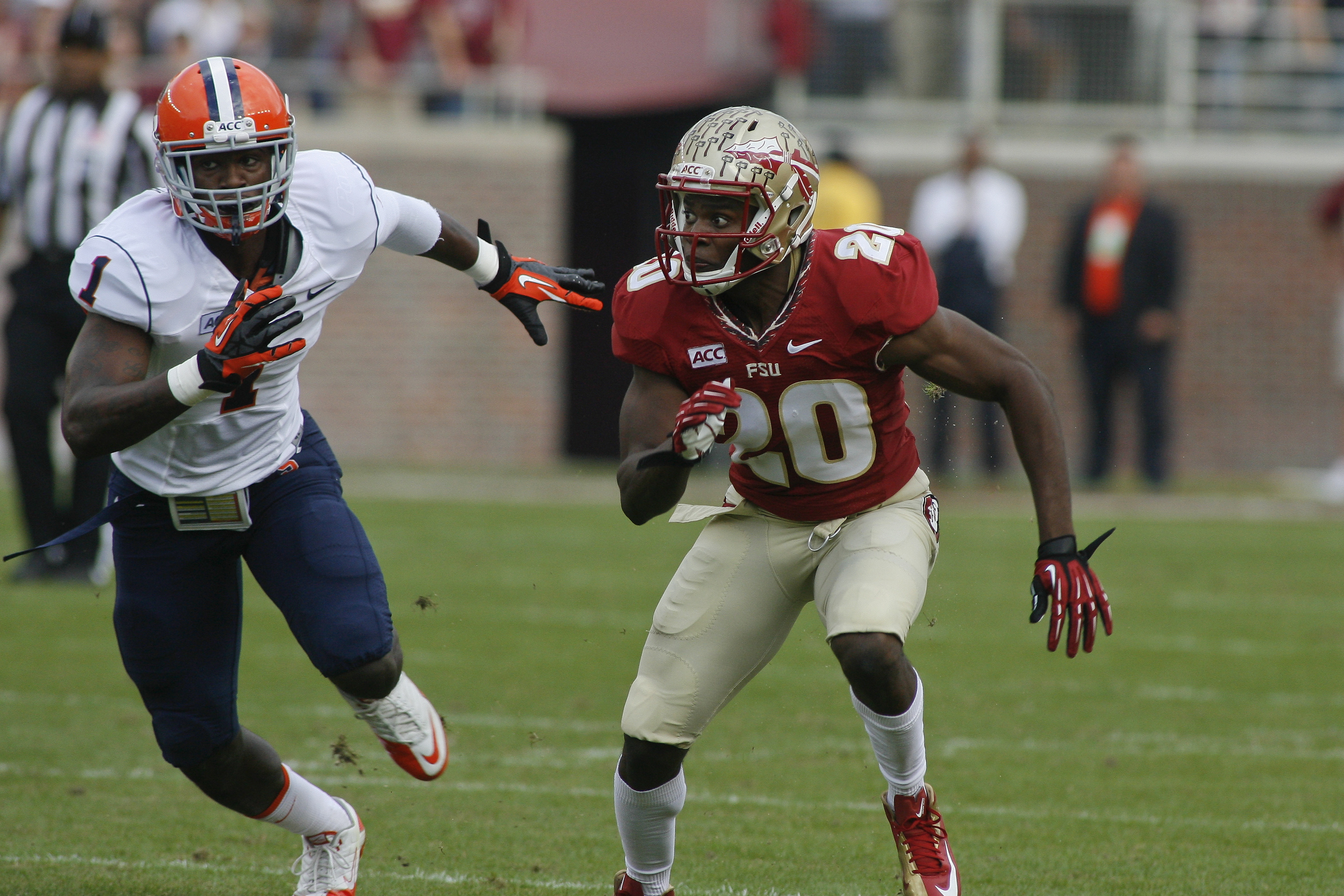 Syracuse running back Ashton Broyld (1) and Florida State defensive back Lamarcus Joyner (20) in the first quarter of an NCAA college football game on Saturday, Nov. 16, 2013 in Tallahassee, Fla. Florida State beat Syracuse 59-3. (AP Photo/Phil Sears)