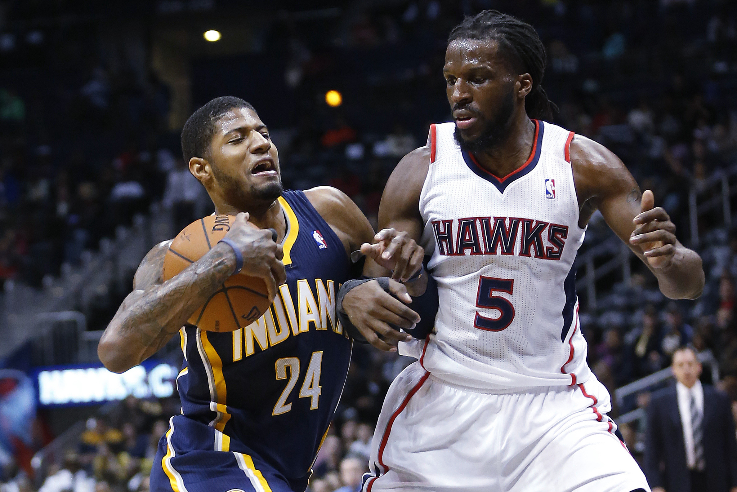 Indiana Pacers small forward Paul George (24) drives against Atlanta Hawks small forward DeMarre Carroll (5) in the first  half of an NBA basketball game, Tuesday, Feb. 4, 2014, in Atlanta. (AP Photo/John Bazemore)