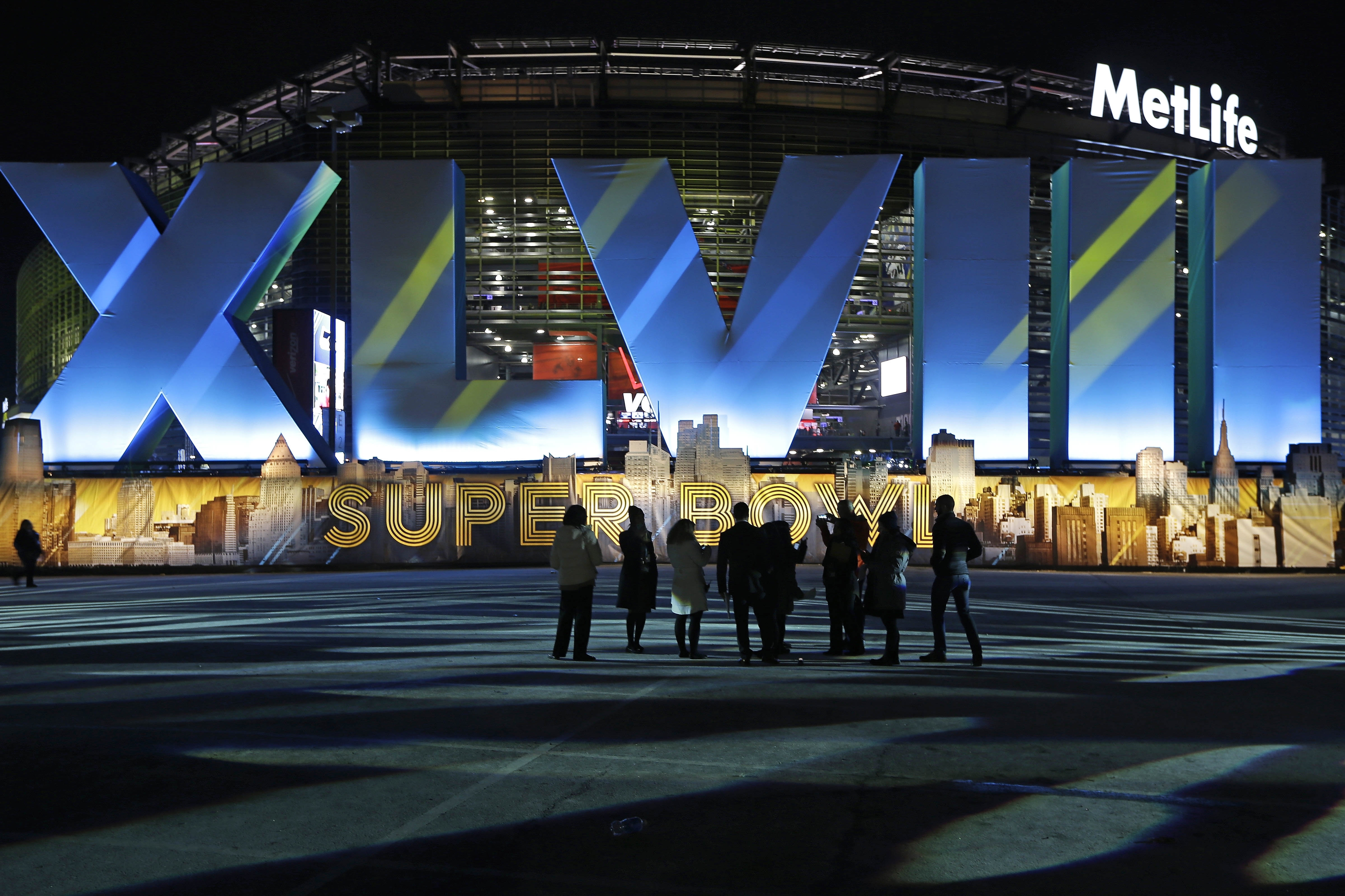 Fans walk near MetLife Stadium before the NFL Super Bowl XLVIII football game between the Seattle Seahawks and the Denver Broncos Sunday, Feb. 2, 2014, in East Rutherford, N.J. (AP Photo/Seth Wenig)