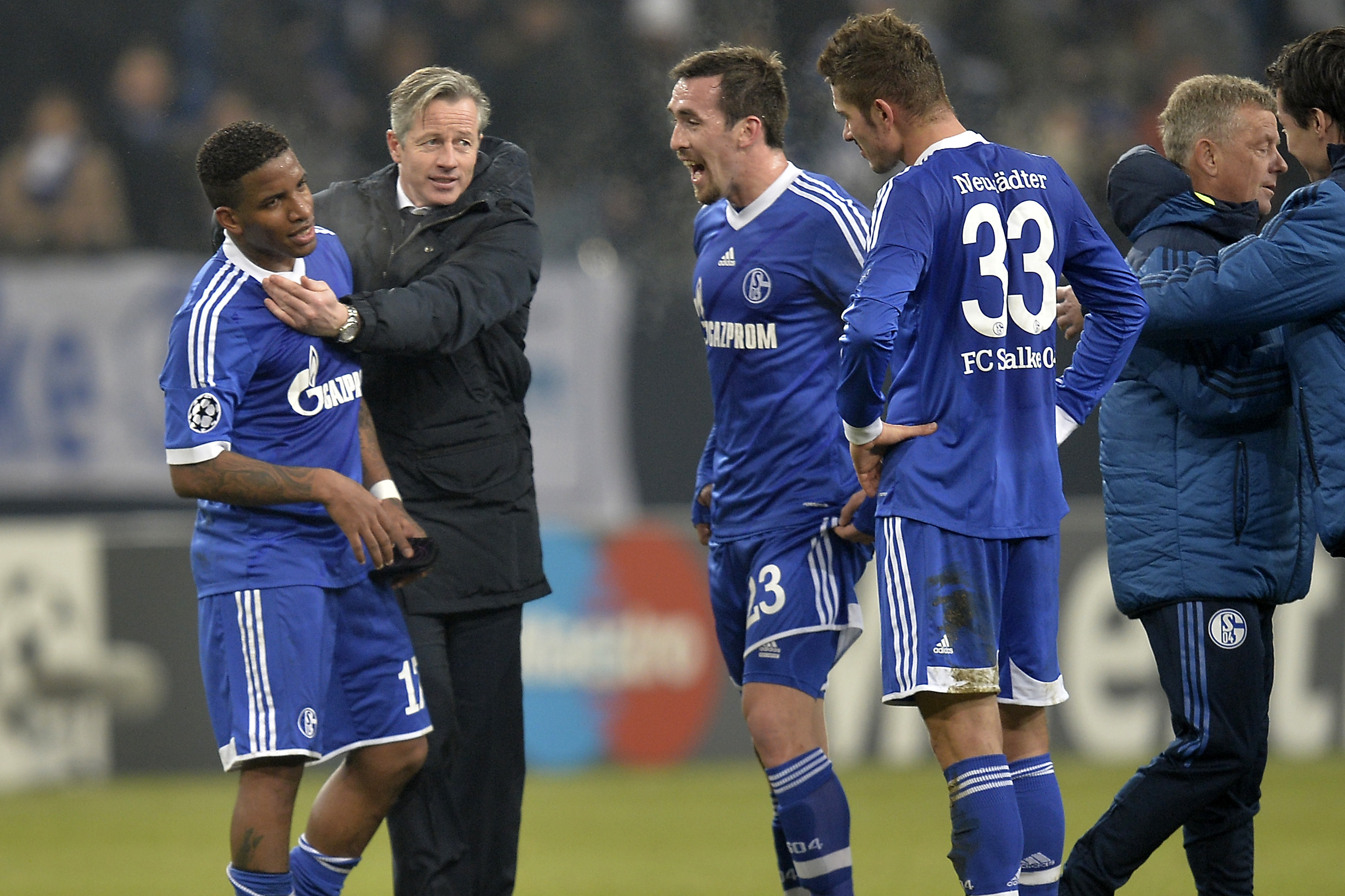 Schalke's Jefferson Farfan, head coach Jens Keller, Christian Fuchs and Roman Neustaedter, from left, joke after the Champions League Group E soccer match between FC Schalke 04 and FC Basel in Gelsenkirchen, Germany, Wednesday, Dec. 11, 2013. Schalke defeated Basel by 2-0. (AP Photo/Martin Meissner)