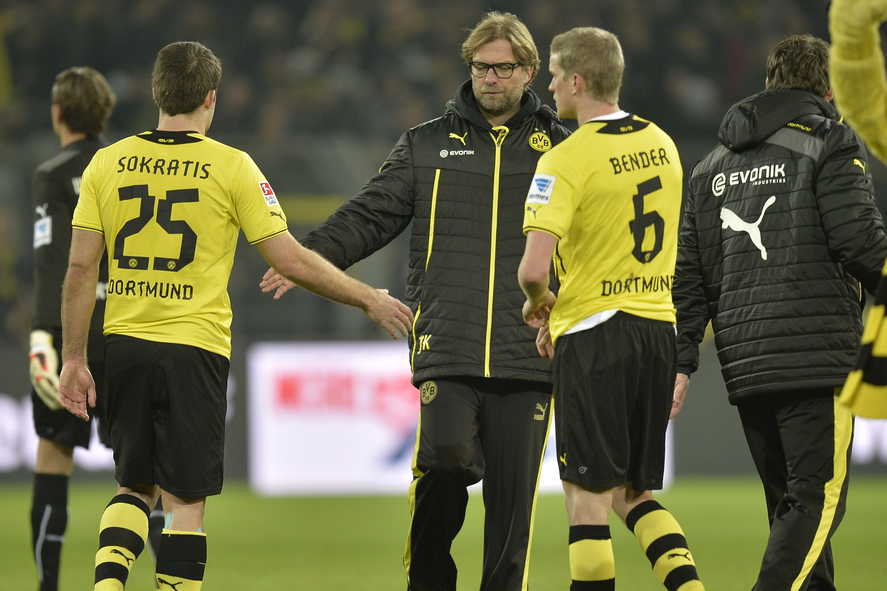 Dortmund head coach Juergen Klopp shakes hands with Sokratis, left, and Sven Bender, right, after the German Bundesliga soccer match between Borussia Dortmund and FC Augsburg in Dortmund,  Germany, Saturday, Jan. 25, 2014. The match ended 2-2.  (AP Photo/Martin Meissner)