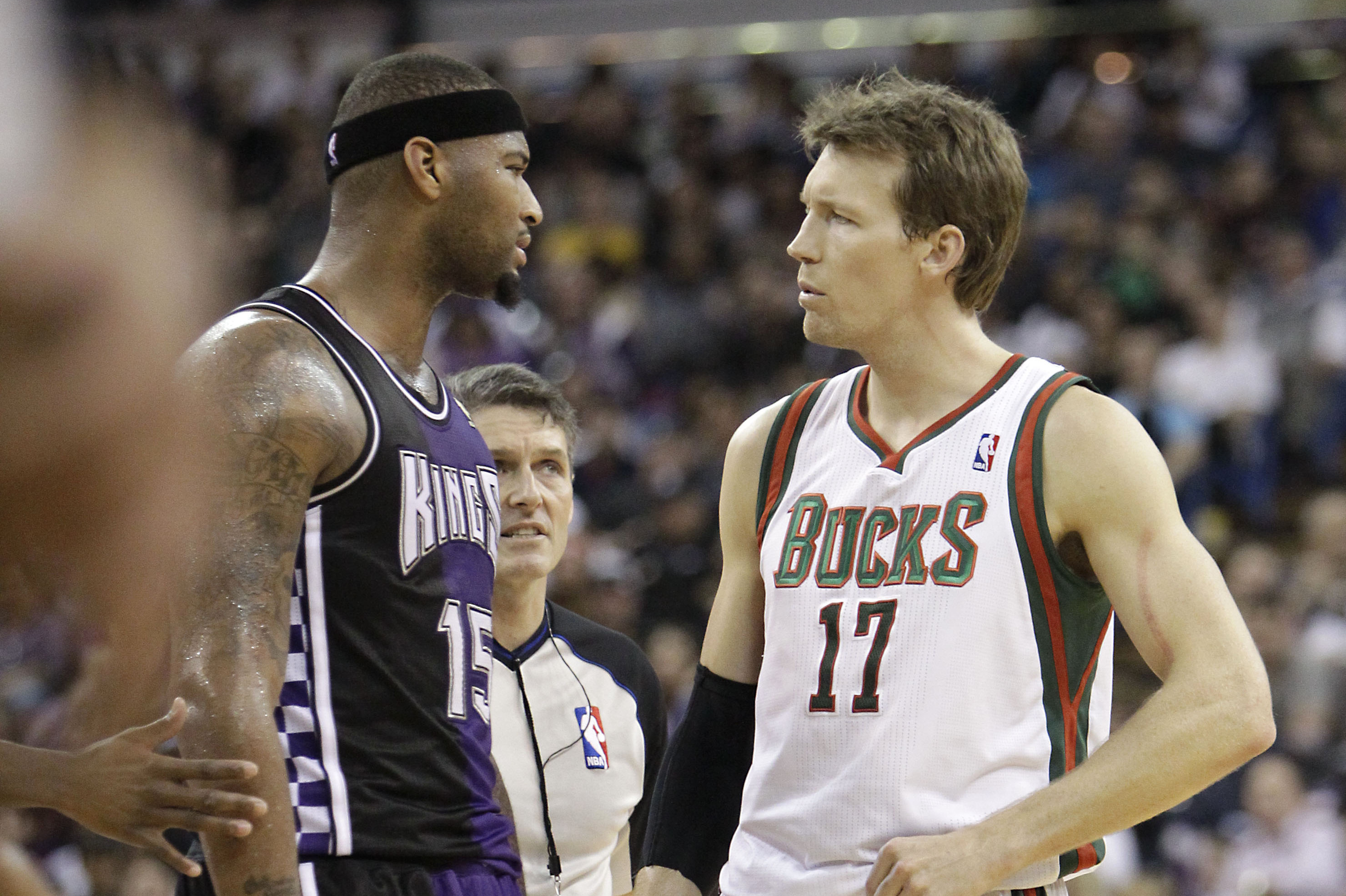 Official Scott Foster, center, steps between Milwaukee Bucks forward Mike Dunleavy, right, Sacramento Kings center DeMarcus Cousins, after they square off during the quarter of an NBA basketball game in Sacramento, Calif., Sunday, March 10, 2013. Cousins was ejected a few minutes later for committing a flagrant foul 2 against Dunleavy.   The Bucks won 115-113.(AP Photo/Rich Pedroncelli)
