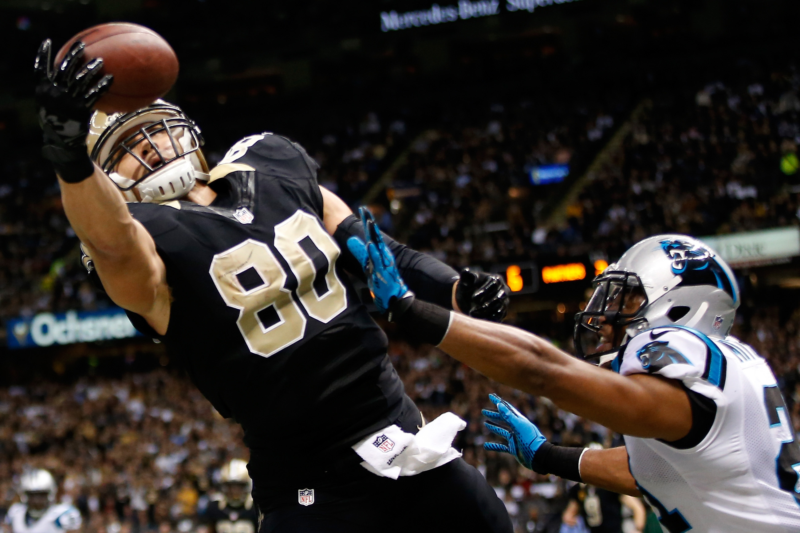 NEW ORLEANS, LA - DECEMBER 08:  Jimmy Graham #80 of the New Orleans Saints has a pass broken up by  Mike Mitchell #21 of the Carolina Panthers at Mercedes-Benz Superdome on December 8, 2013 in New Orleans, Louisiana.  (Photo by Chris Graythen/Getty Images)