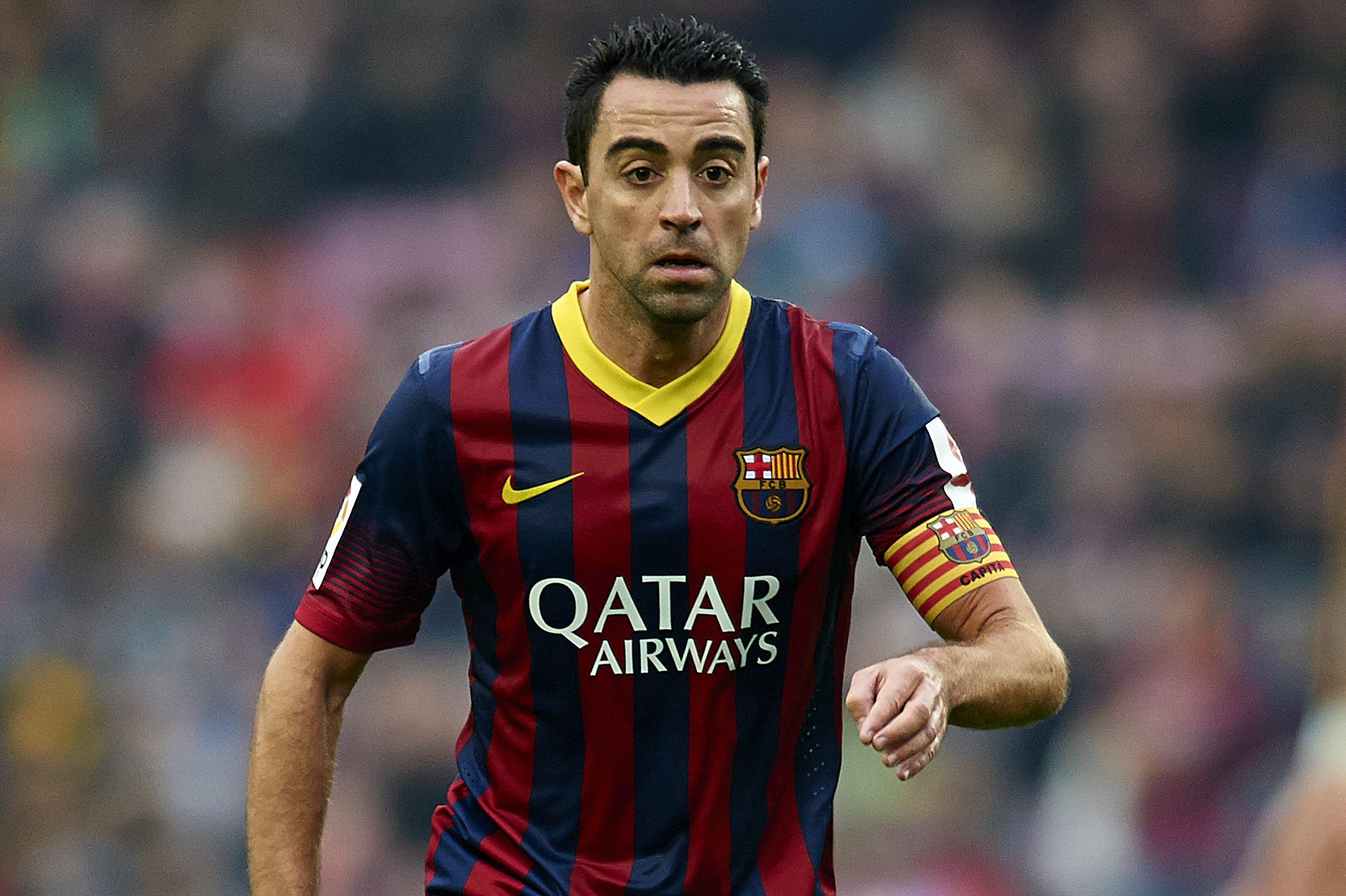 BARCELONA, SPAIN - FEBRUARY 01:  Xavi Hernandez of FC Barcelona runs with the ball during the La Liga match between FC Barcelona and Valencia CF at Camp Nou on February 1, 2014 in Barcelona, Spain.  (Photo by Manuel Queimadelos Alonso/Getty Images)