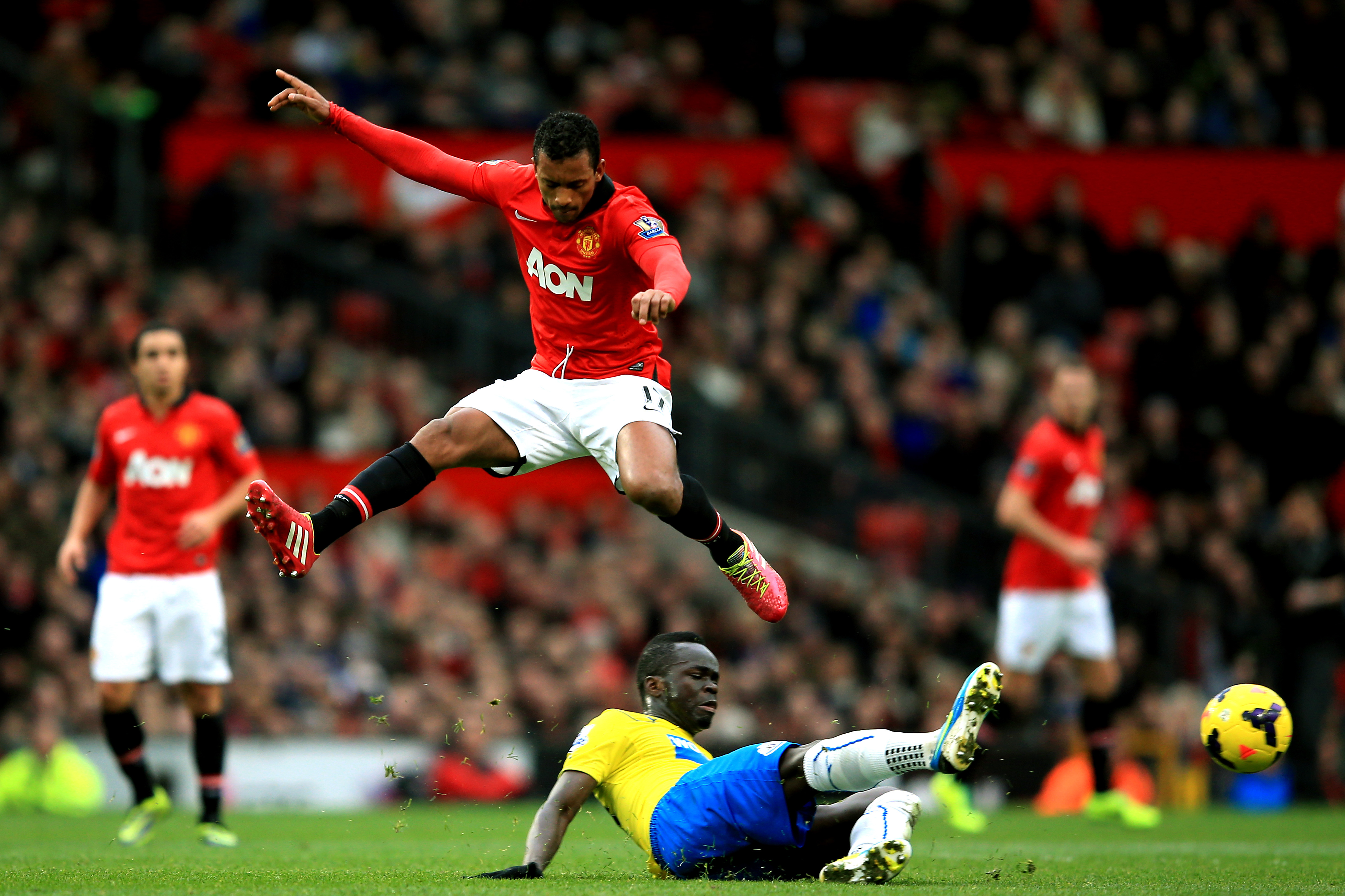MANCHESTER, ENGLAND - DECEMBER 07:  Nani of Manchester United hurrdles the tackle from Cheik Ismael Tiote of Newcastle during the Barclays Premier League match between Manchester United and Newcastle United at Old Trafford on December 7, 2013 in Manchester, England.  (Photo by Richard Heathcote/Getty Images)