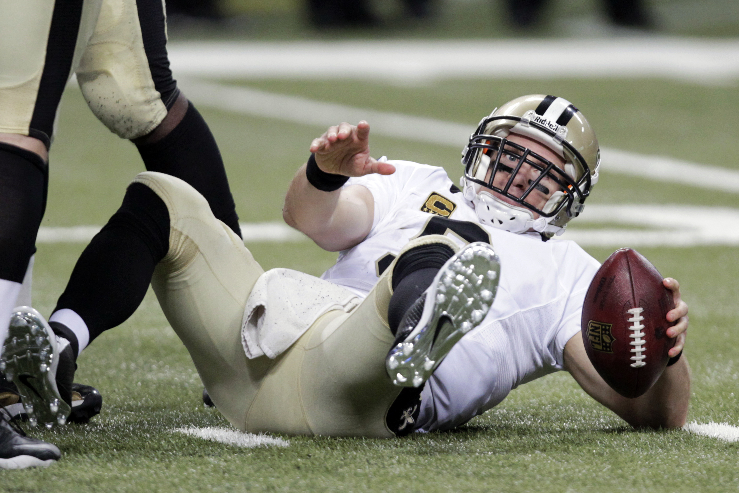 New Orleans Saints quarterback Drew Brees gets up slowly after being sacked for a 6-yard loss by St. Louis Rams defensive end William Hayes during the fourth quarter of an NFL football game Sunday, Dec. 15, 2013, in St. Louis. The Rams won 27-16. (AP Photo/Tom Gannam)