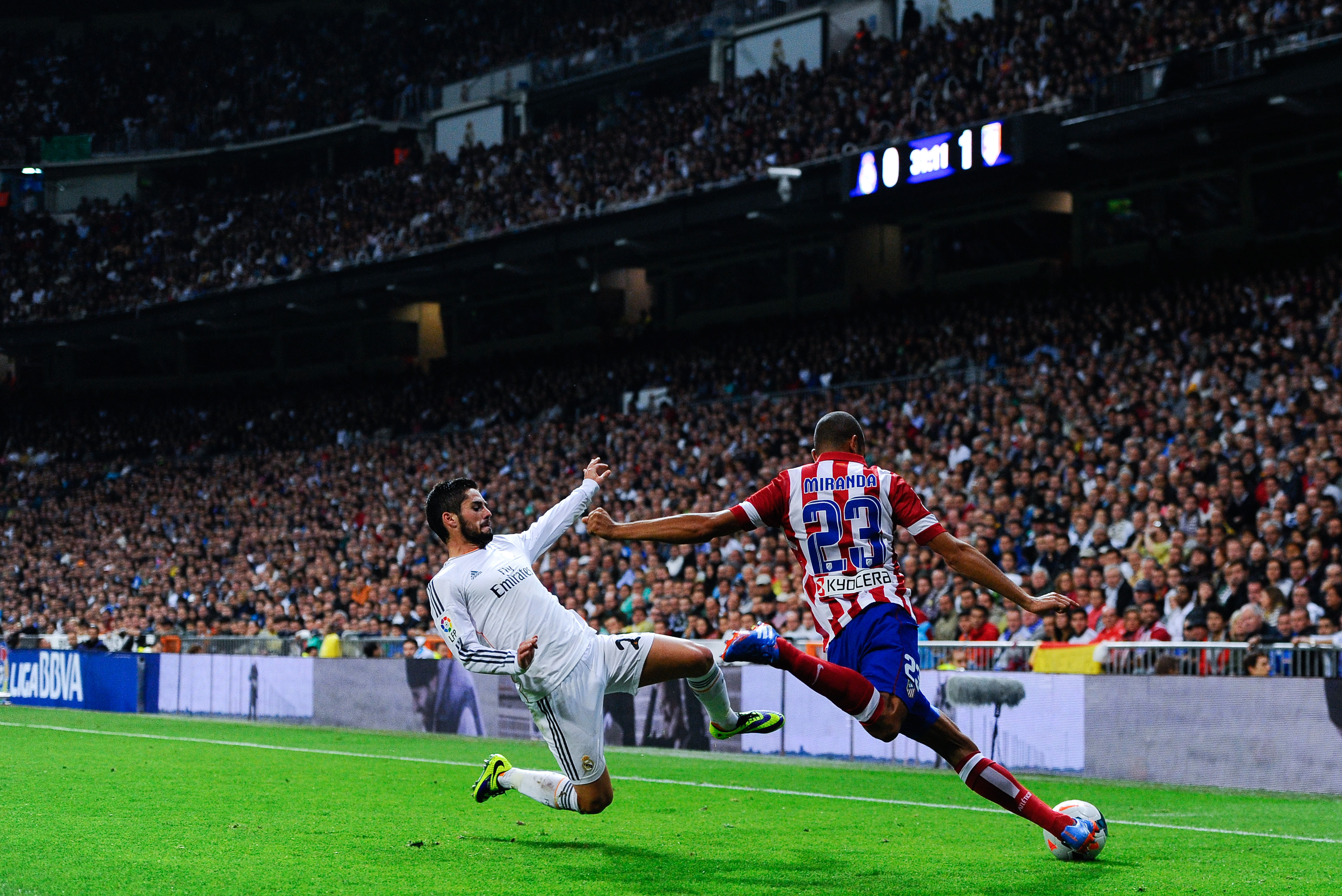 MADRID, SPAIN - SEPTEMBER 28:  Joao Miranda of Atletico de Madrid clear the ball under pressure from Francisco Alarcon Isco of Real Madrid CF during the La Liga match between Real Madrid CF and Club Atletico de Madrid at Bernabeu on September 28, 2013 in Madrid, Spain.  (Photo by David Ramos/Getty Images)