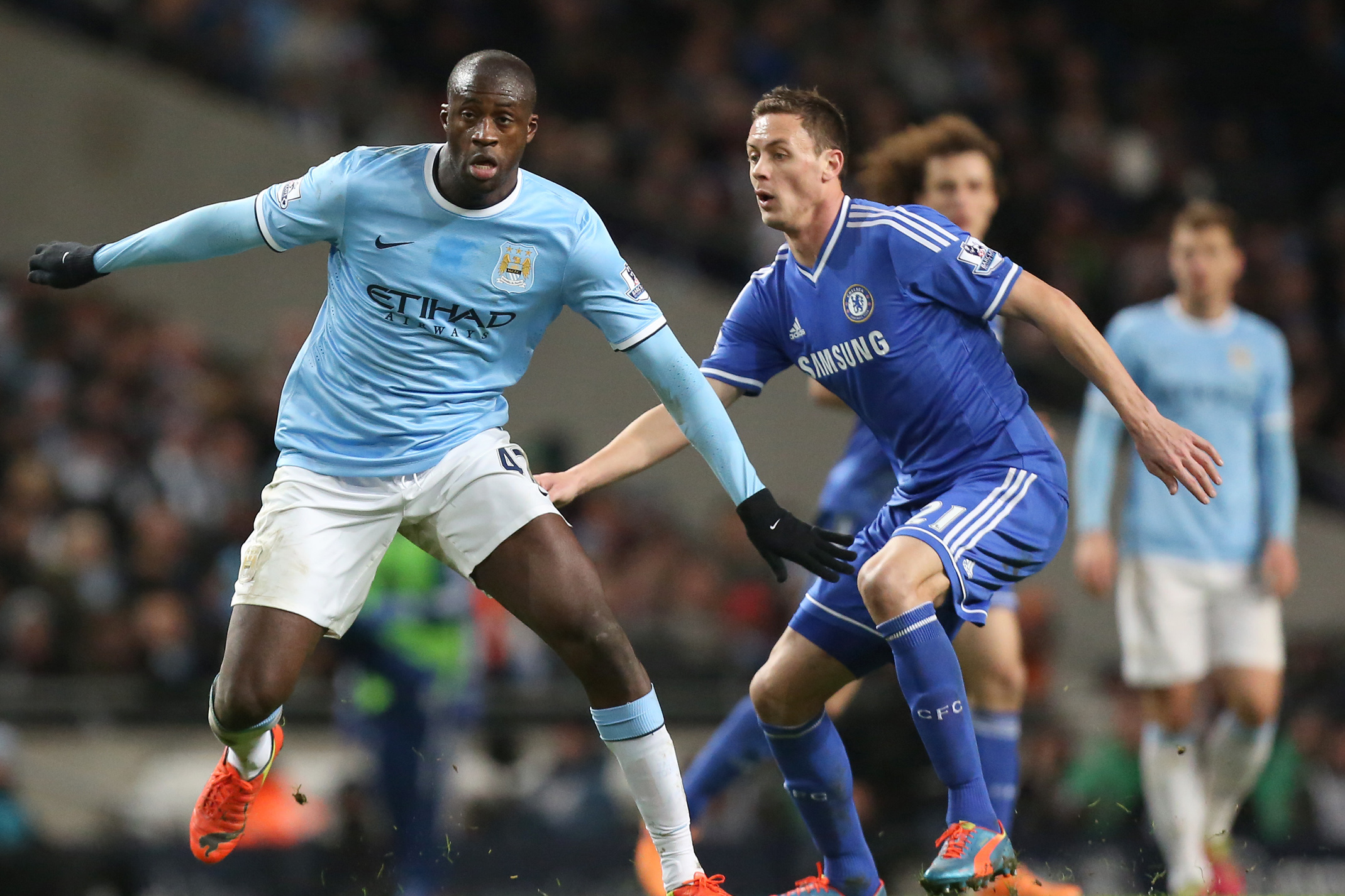 Manchester City's Yaya Toure, left, shields the ball from Chelsea's Nemanja Matic during their English Premier League soccer match at the Etihad Stadium, Manchester, England, Monday Feb. 3, 2014. (AP Photo/Jon Super)