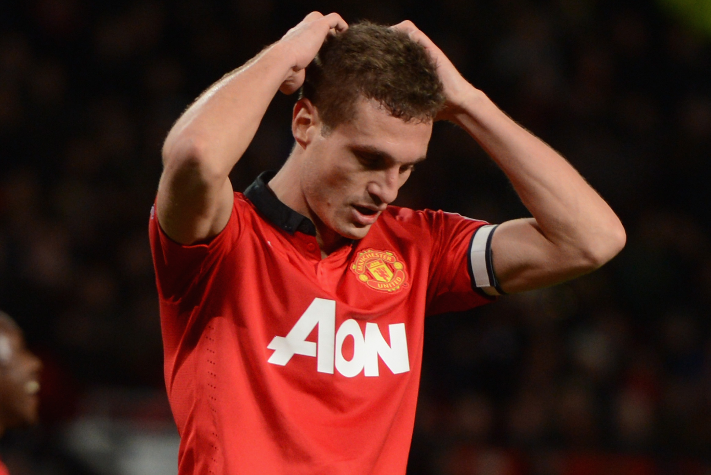 MANCHESTER, ENGLAND - JANUARY 01:  Nemanja Vidic of Manchester United reacts during the Barclays Premier League match between Manchester United and Tottenham Hotspur at Old Trafford on January 1, 2014 in Manchester, England.  (Photo by Michael Regan/Getty Images)