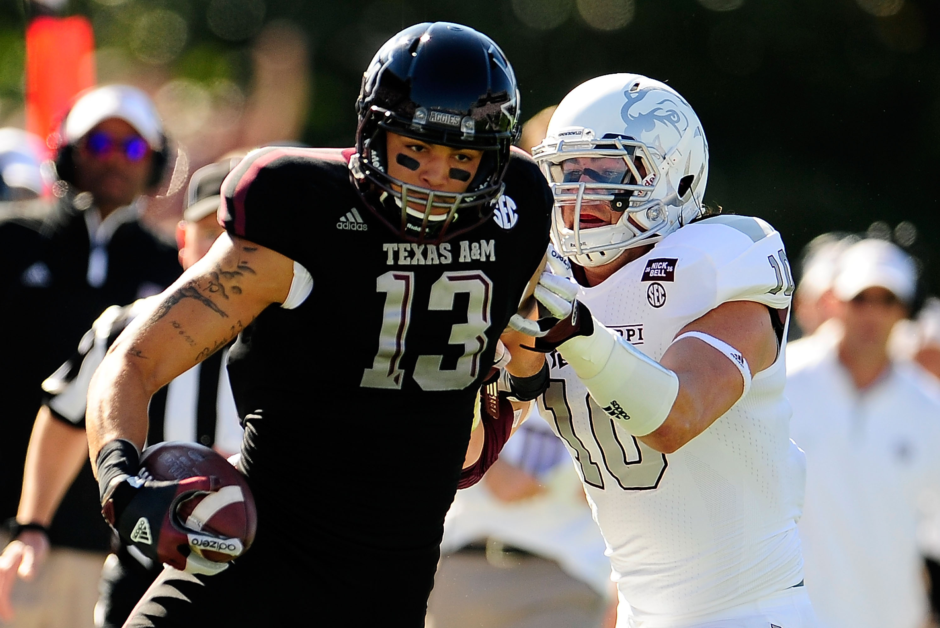 STARKVILLE, MS - NOVEMBER 03:  Mike Evans #13 of the Texas A&M Aggies avoids a tackle by Cameron Lawrence #10 of the Mississippi State Bulldogs at Wade Davis Stadium on November 3, 2012 in Starkville, Mississippi.  (Photo by Stacy Revere/Getty Images)