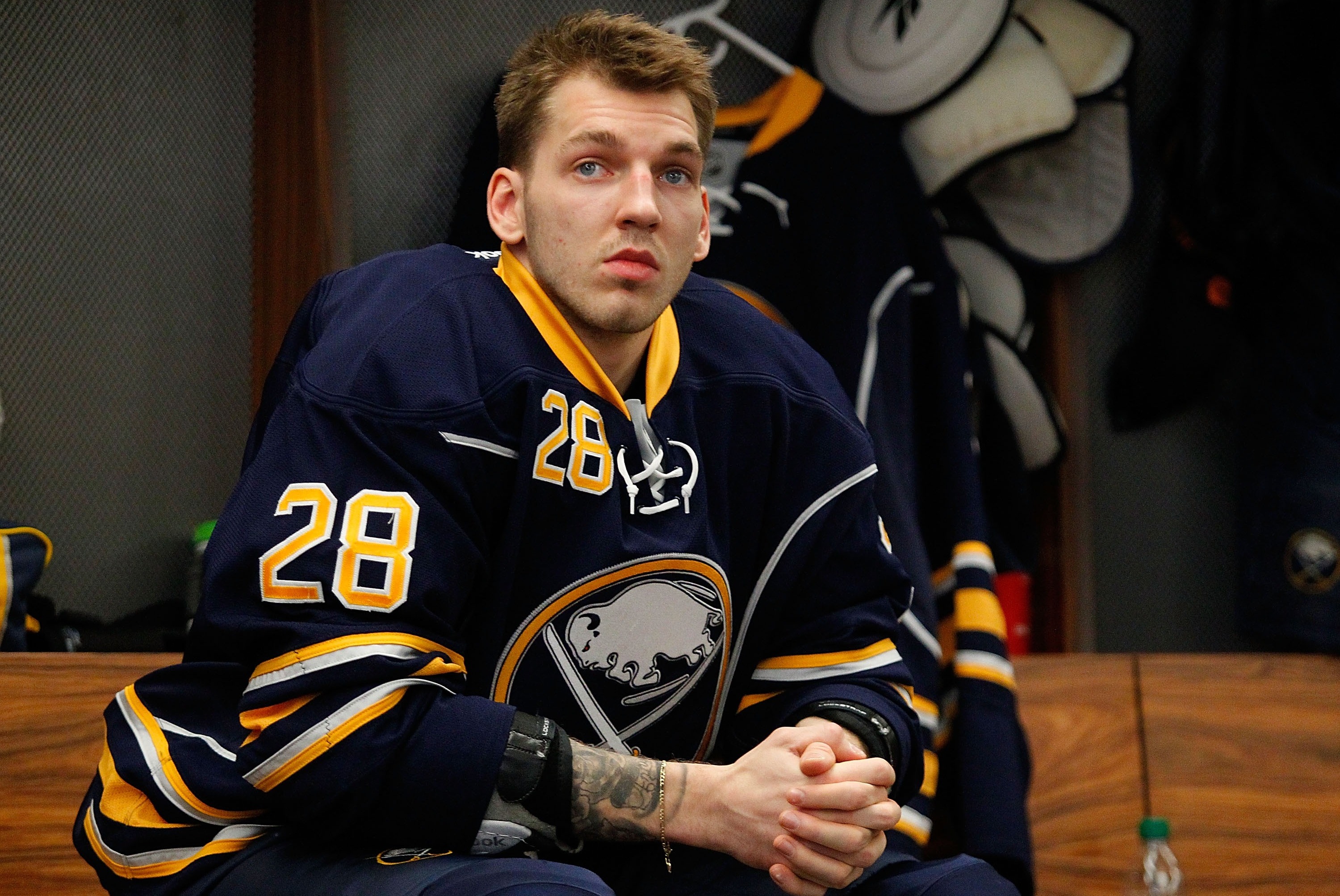 BUFFALO, NY - DECEMBER 29: Zemgus Girgensons #28 of the Buffalo Sabres sits in the locker room preparing to play the Washington Capitals on December 29, 2013 at the First Niagara Center in Buffalo, New York.  (Photo by Bill Wippert/NHLI via Getty Images)