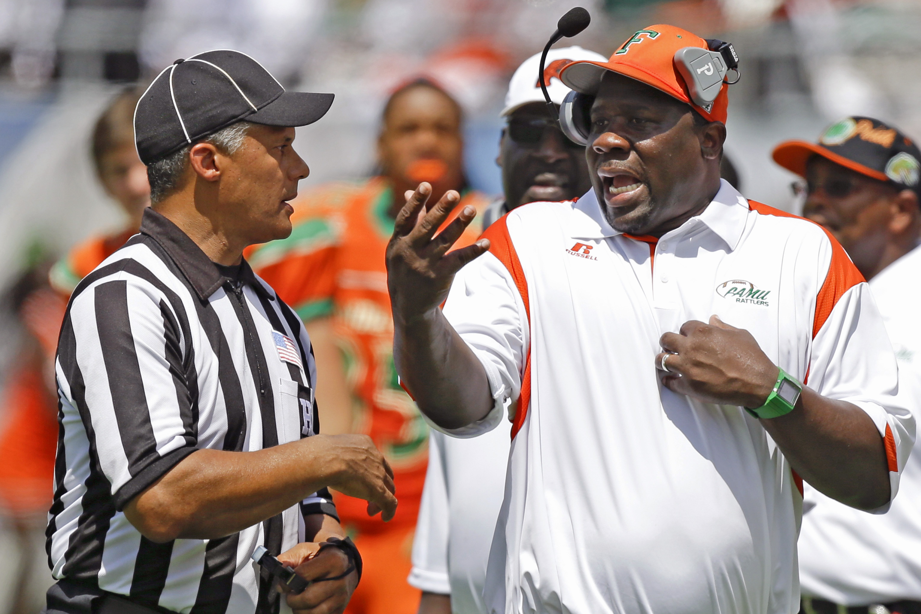 Florida A&M head coach Earl Homes, right, has words with an official on the sideline during the second half of an NCAA college football game against Mississippi Valley State in Orlando, Fla., Sunday, Sept. 1, 2013. (AP Photo/John Raoux)