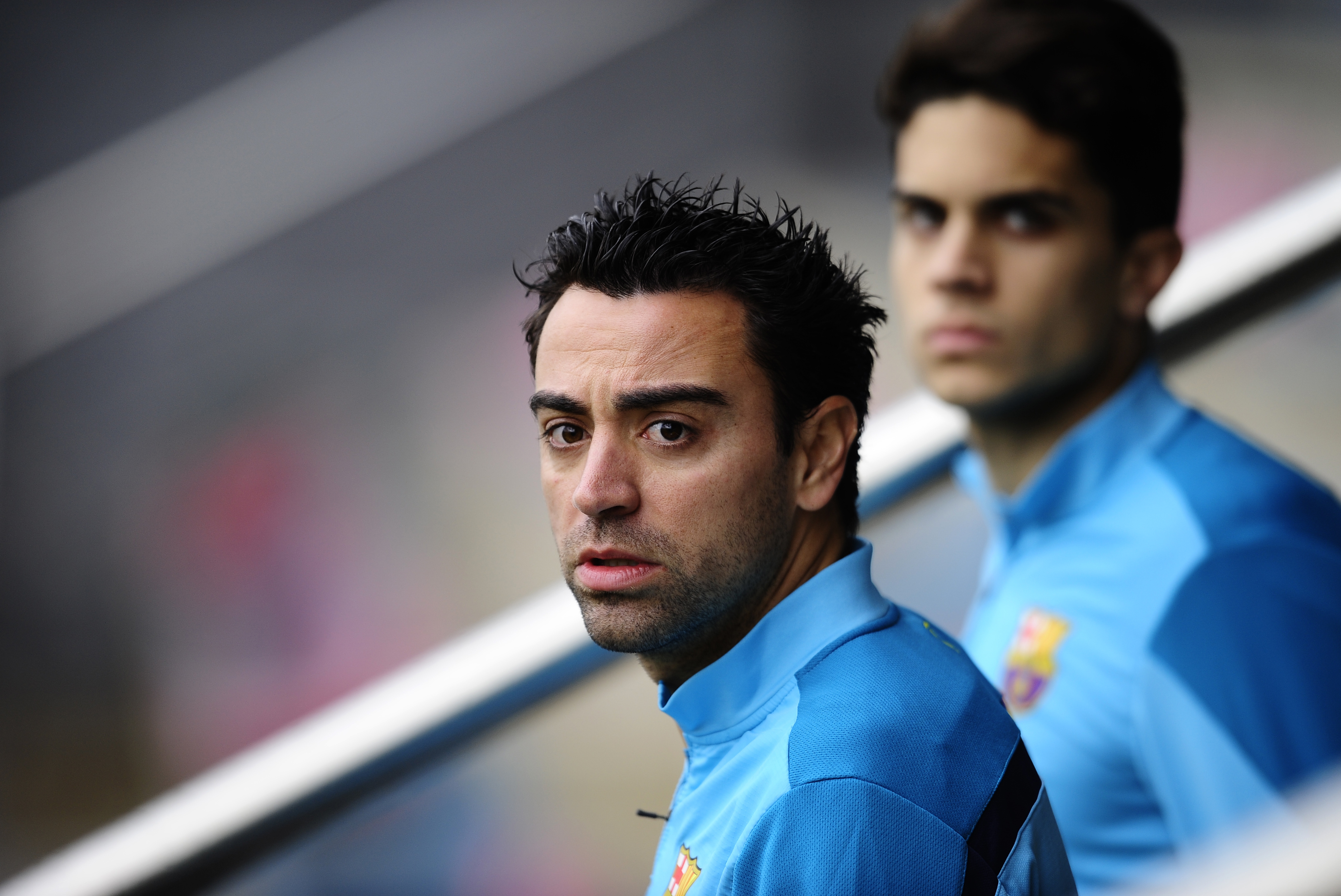FC Barcelona's Xavi Hernandez, left, and Marc Bartra arrive for a training session at the Sports Center FC Barcelona Joan Gamper in San Joan Despi, Spain, Saturday, Jan. 18, 2014. (AP Photo/Manu Fernandez)