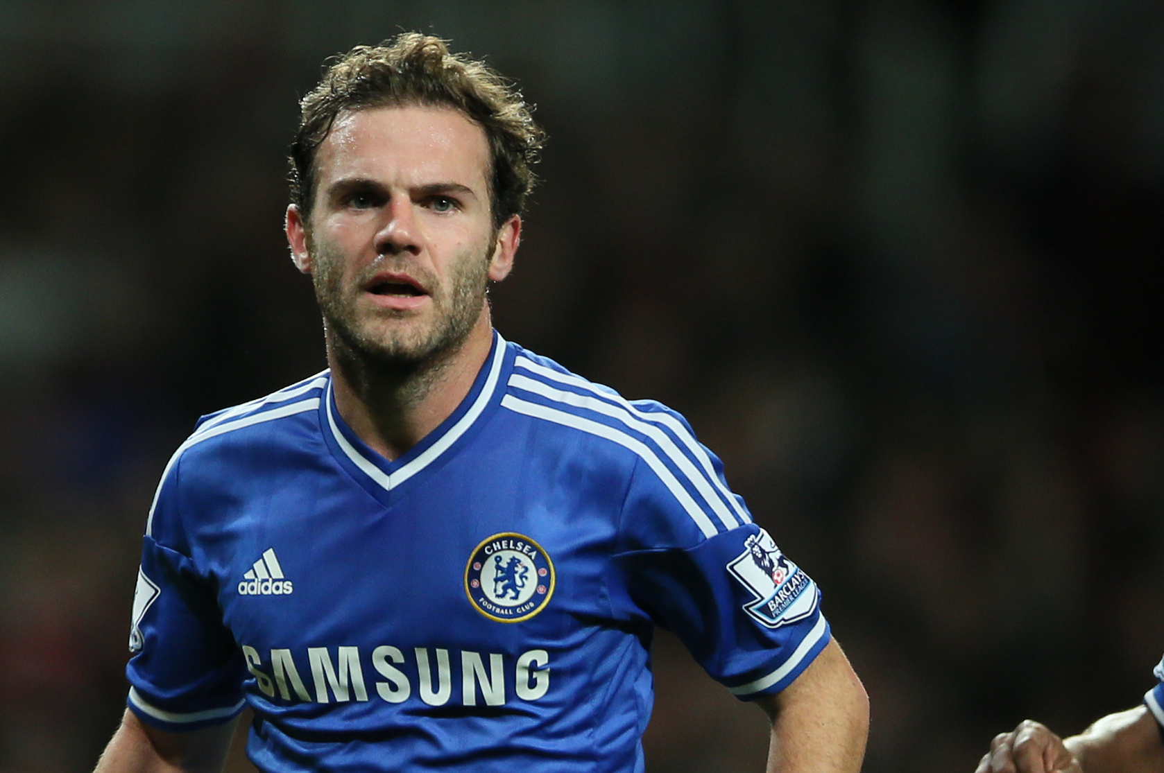 Chelsea's Juan Mata,  left, celebrates after scoring his teams second goal during their English League Cup soccer match between Arsenal and Chelsea at the Emirates stadium in London Tuesday, Oct. 29, 2013. (AP Photo/Alastair Grant)