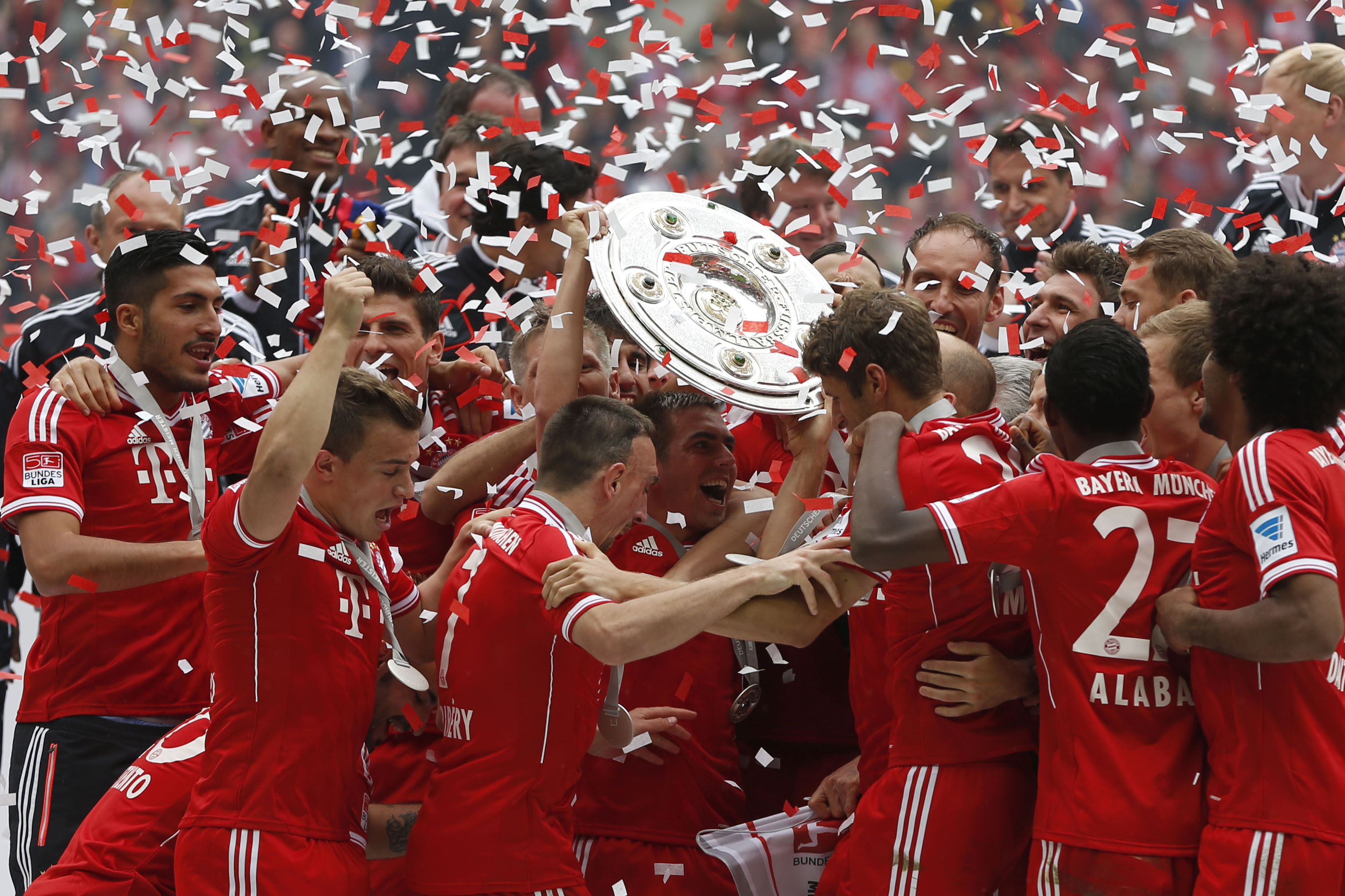 Munich's players celebrate with the trophy for winning the German Soccer Championship  after  the  match between FC Bayern Munich and FC Augsburg, in Munich, southern Germany, Saturday, May 11, 2013. (AP Photo/Matthias Schrader)