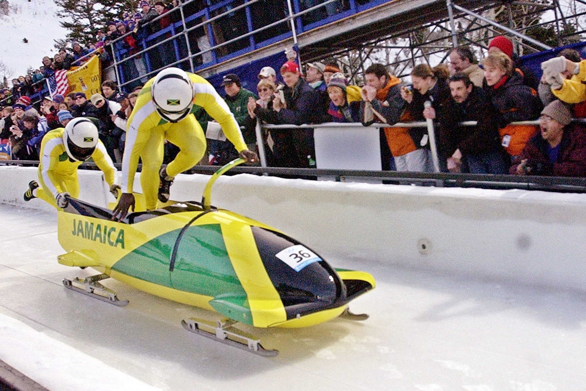 Winston Alexander Watt and Lascelles Oneil Brown of Jamaica in JAM-1, pushes off during the men's two-man bobsled at the Salt Lake City Winter Olympics in Park City, Utah, Saturday, Feb. 16, 2002. (AP Photo/Joe Cavaretta)