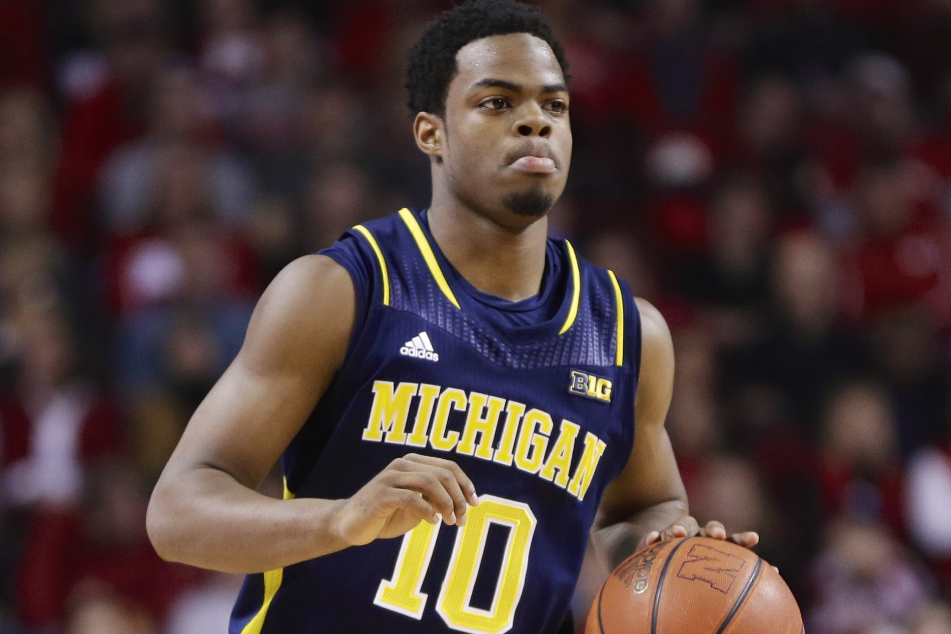 Michigan's Derrick Walton Jr. (10) handles the ball in the first half of an NCAA college basketball game against Nebraska in Lincoln, Neb., Thursday, Jan. 9, 2014. (AP Photo/Nati Harnik)