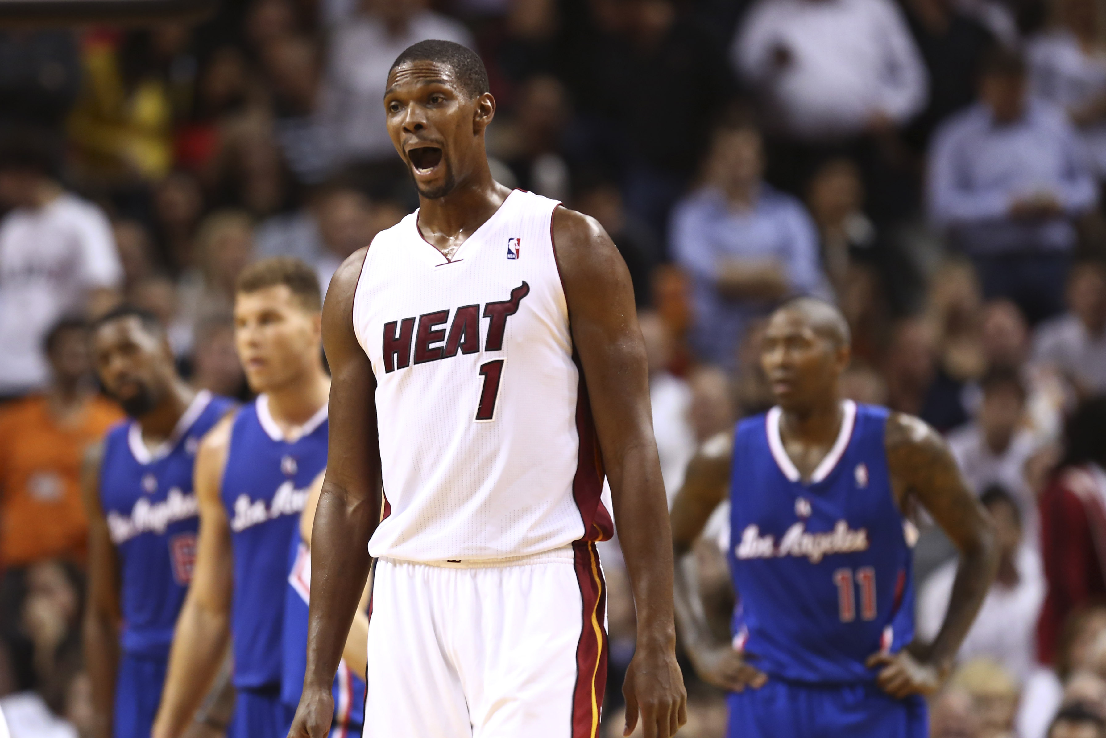Miami Heat's Chris Bosh celebrates during the final minutes of play against the Los Angeles Clippers during the second half of an NBA basketball game in Miami, Thursday, Nov. 7, 2013. The Heat won 102-97. (AP Photo/J Pat Carter)