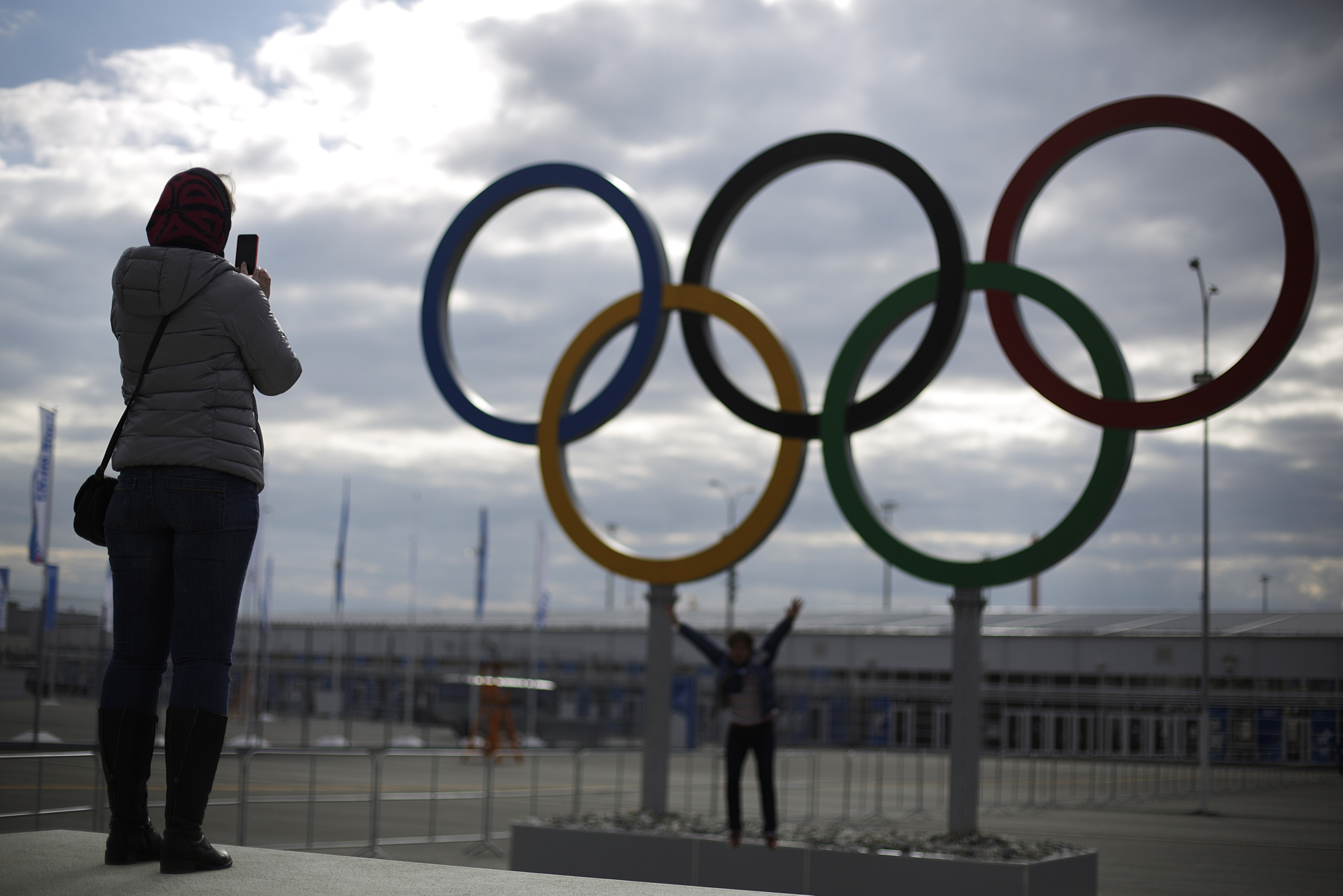 Railway passengers take photos in front of the Olympic Rings at the Olympic Park train station ahead of the upcoming 2014 Winter Olympics, Wednesday, Feb. 5, 2014, in Sochi, Russia. (AP Photo/David Goldman)