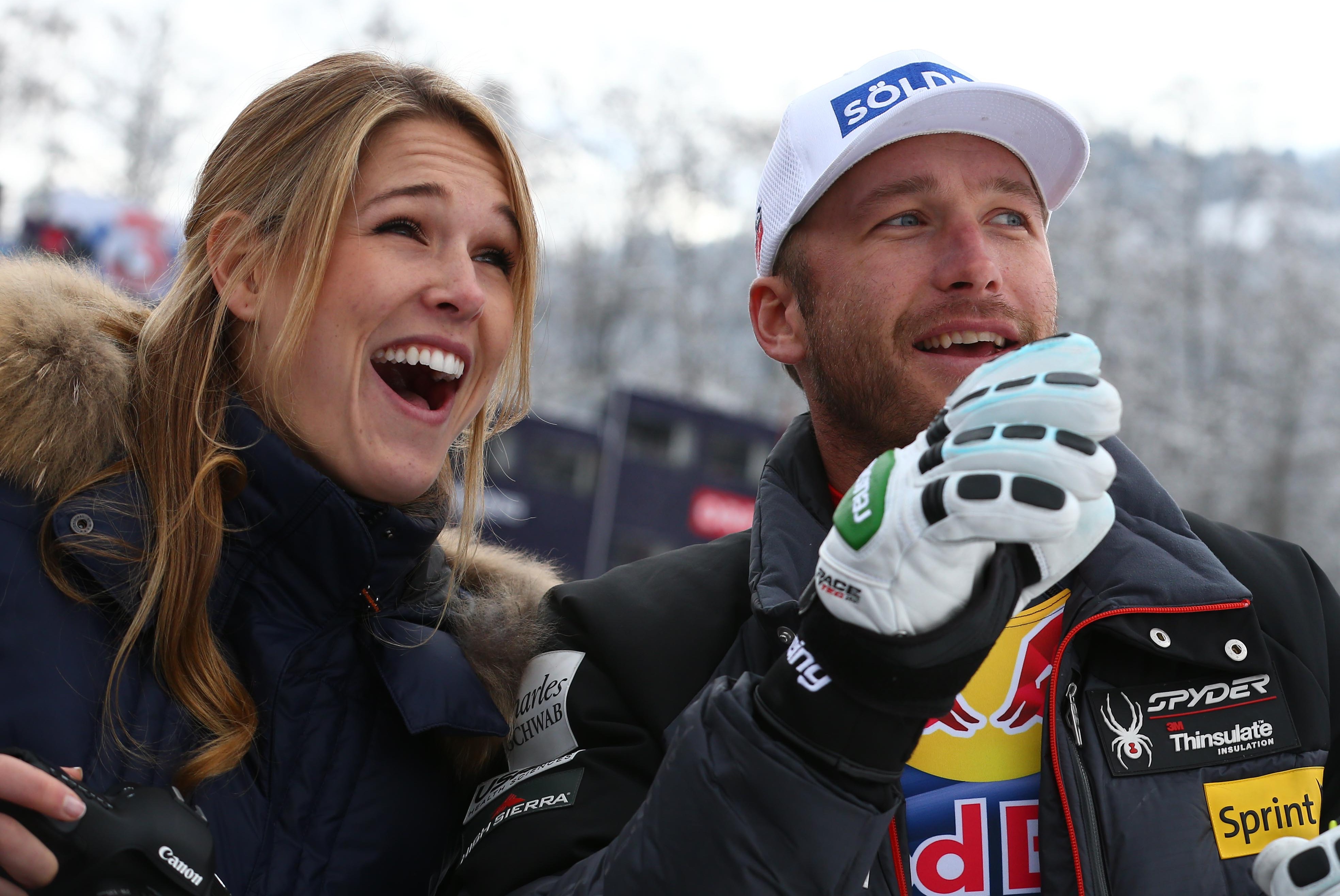 Bode Miller, of the United States, and his wife Morgan smile at the finish area at the end of an alpine ski, men's World Cup downhill, in Kitzbuehel, Austria, Saturday, Jan. 25, 2014. (AP Photo/Giovanni Auletta)