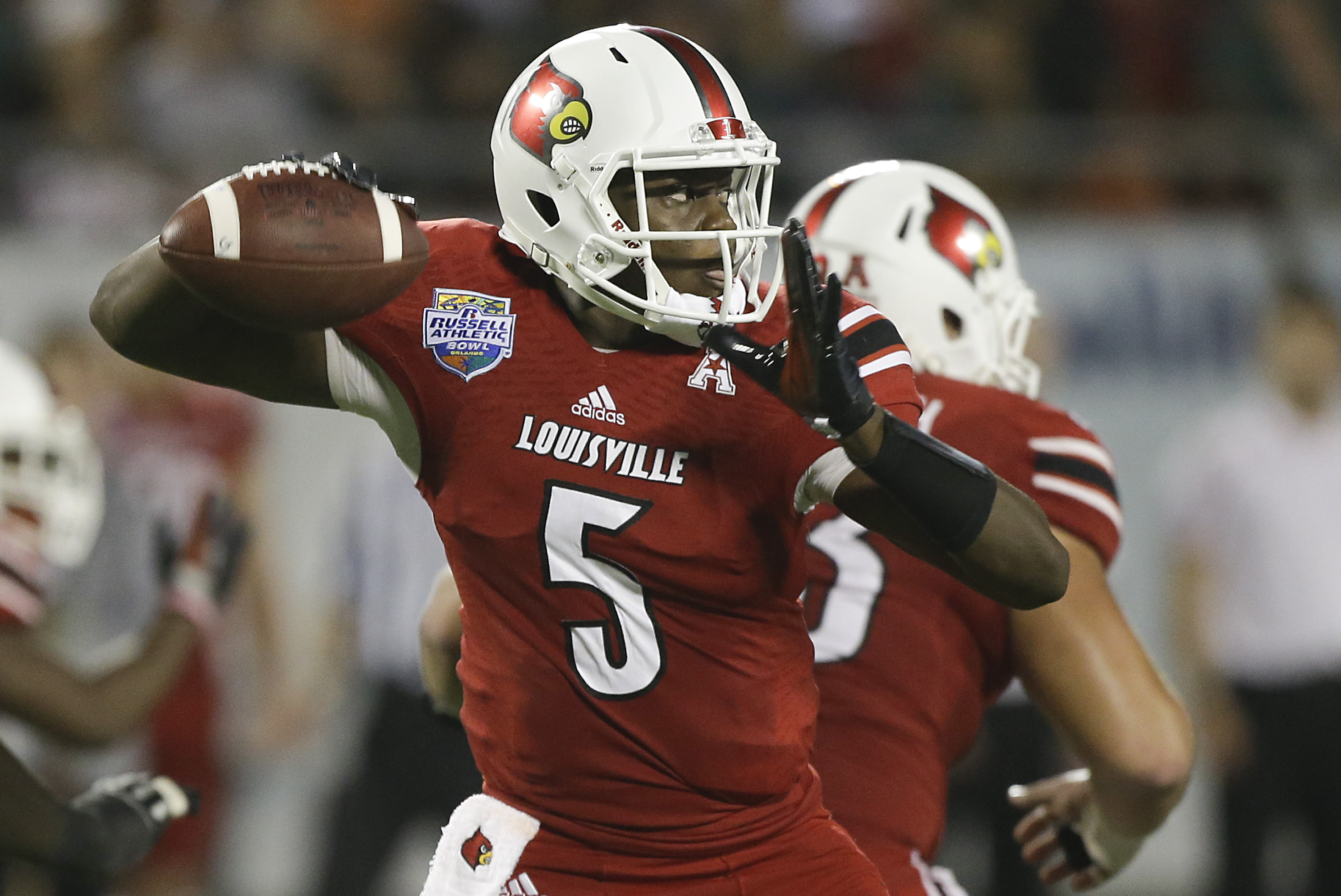 Louisville quarterback Teddy Bridgewater throws a pass during the first half of the Russell Athletic Bowl NCAA college football game against Miami in Orlando, Fla., Saturday, Dec. 28, 2013.(AP Photo/John Raoux)
