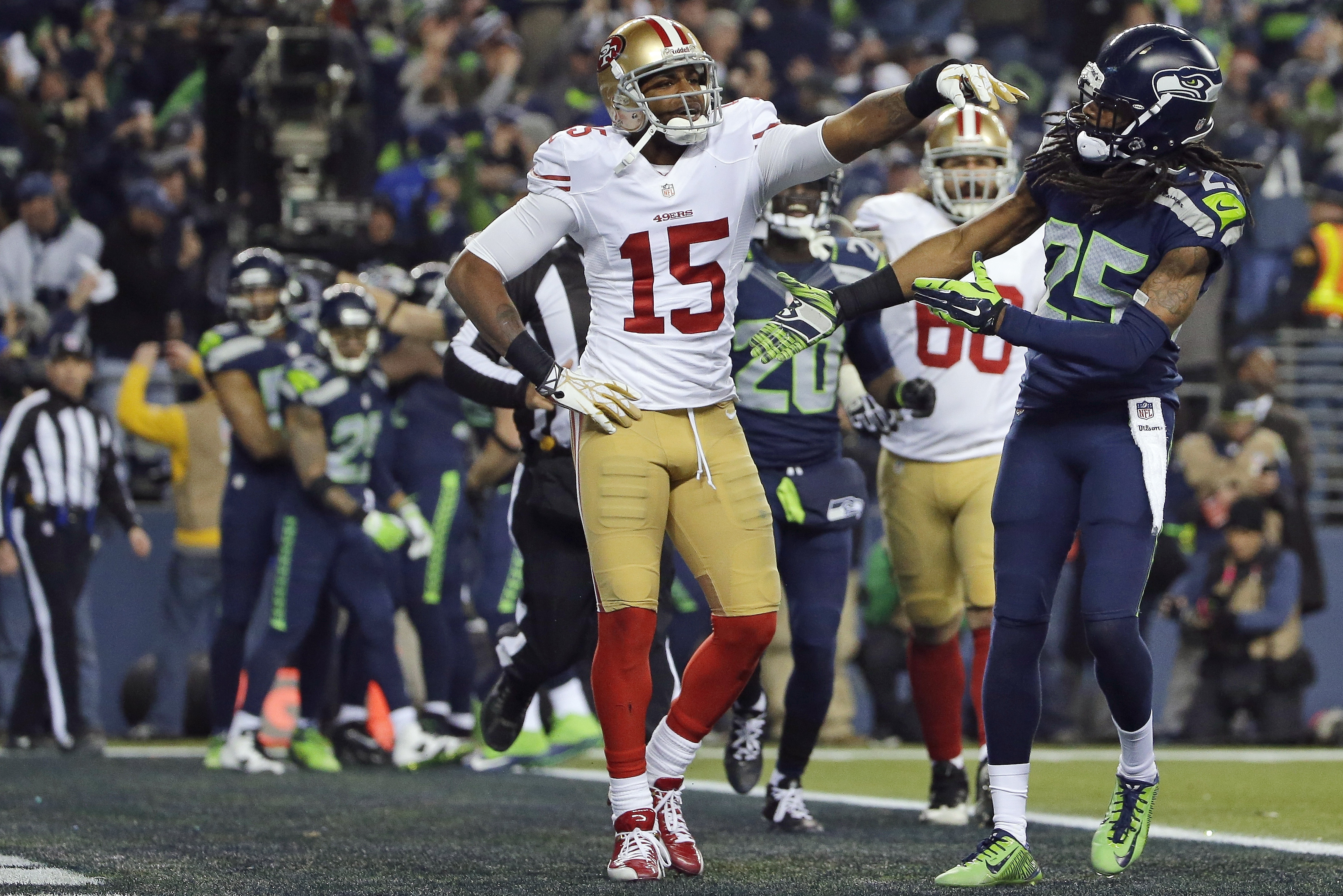 FILE- In this Jan. 19, 2014, file photo, Seattle Seahawks' Richard Sherman (25) reaches out to shake hands with San Francisco 49ers' Michael Crabtree (15) after Sherman tipped a pass in the end zone intended for Crabtree in the final minute of the second half of the NFC championship NFL football game in Seattle. Seattle's Malcolm Smith intercepted the tipped pass. Sherman was fined $7,875 for unsportsmanlike conduct/taunting after he made a choking gesture after the play toward the San Francisco bench after the play that he said was directed at quarterback Colin Kaepernick.  (AP Photo/Matt Slocum, File)