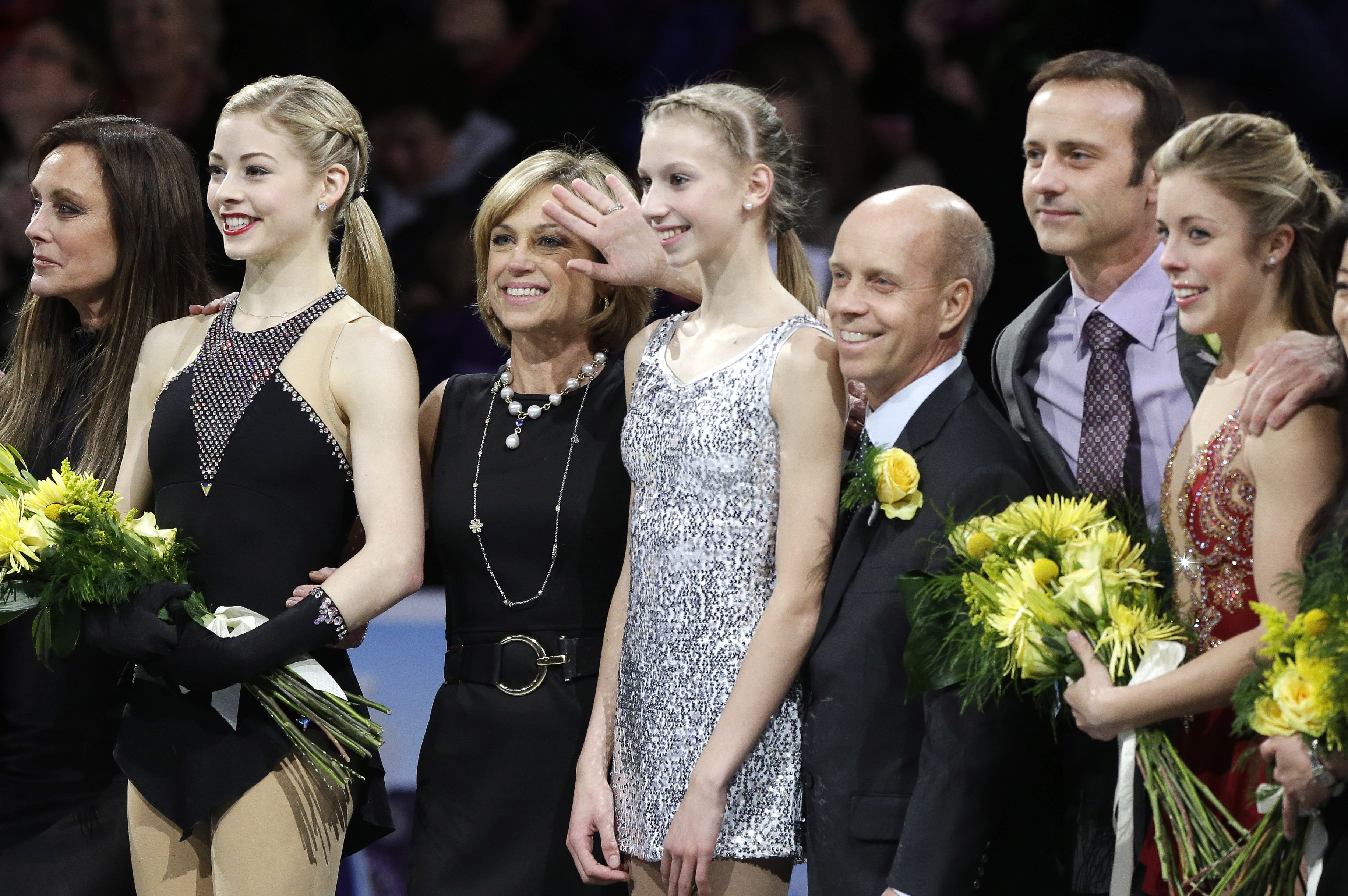 Figure skaters, from the left, Peggy Fleming, Gracie Gold, Dorothy Hamill, Polina Edmunds, Scott Hamilton, Brian Boitano, Ashley Wagner, and Kristi Yamaguchi, stand together following the U.S. Figure Skating Championships Sunday, Jan. 12, 2014 in Boston. (AP Photo/Steven Senne)