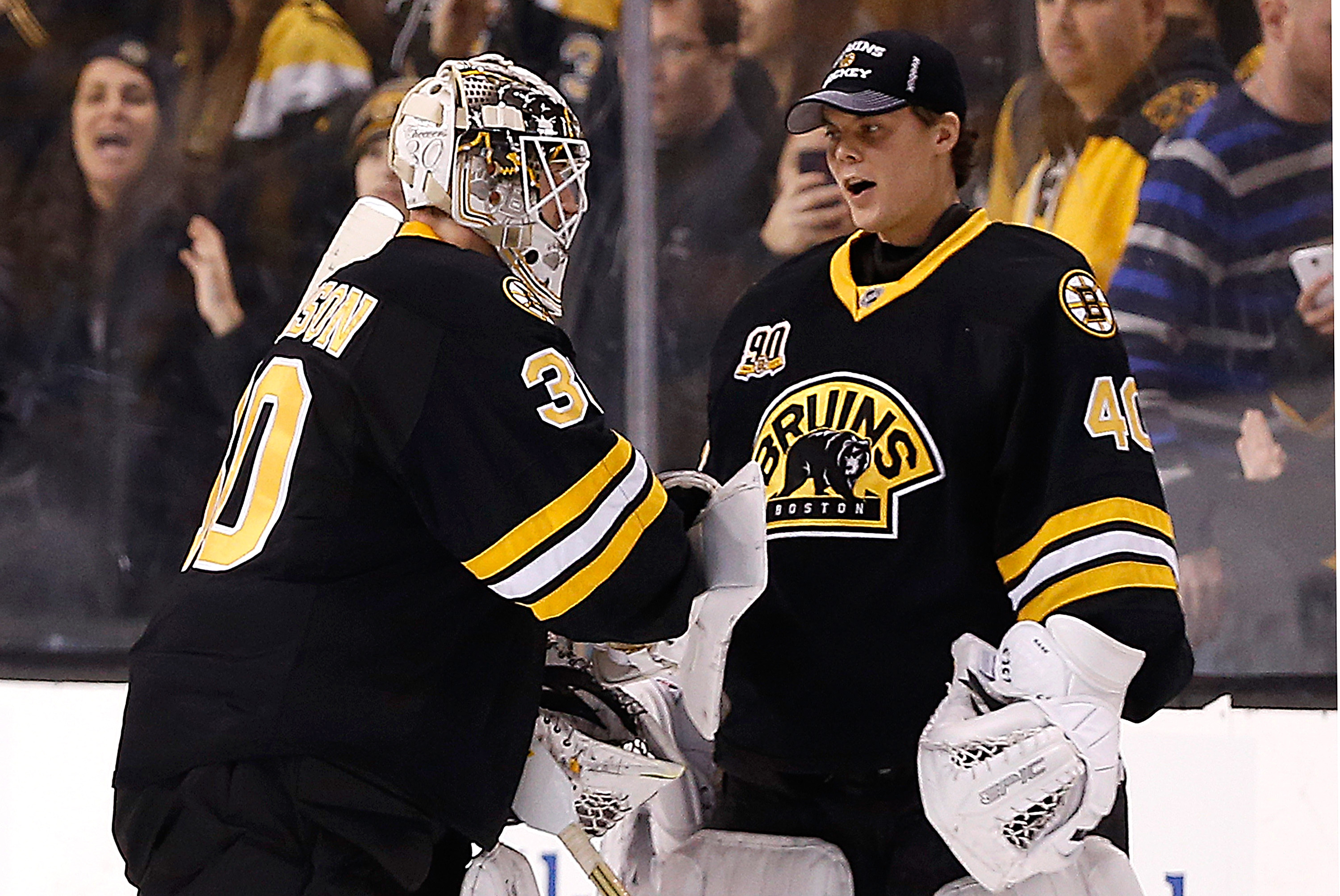 BOSTON, MA - FEBRUARY 1:  Chad Johnson #30 of the Boston Bruins celebrates his 4-0 shutout against the Edmonton Oilers with teammates Tuukka Rask #40 at TD Garden on February 1, 2014 in Boston, Massachusetts.  (Photo by Jim Rogash/Getty Images)
