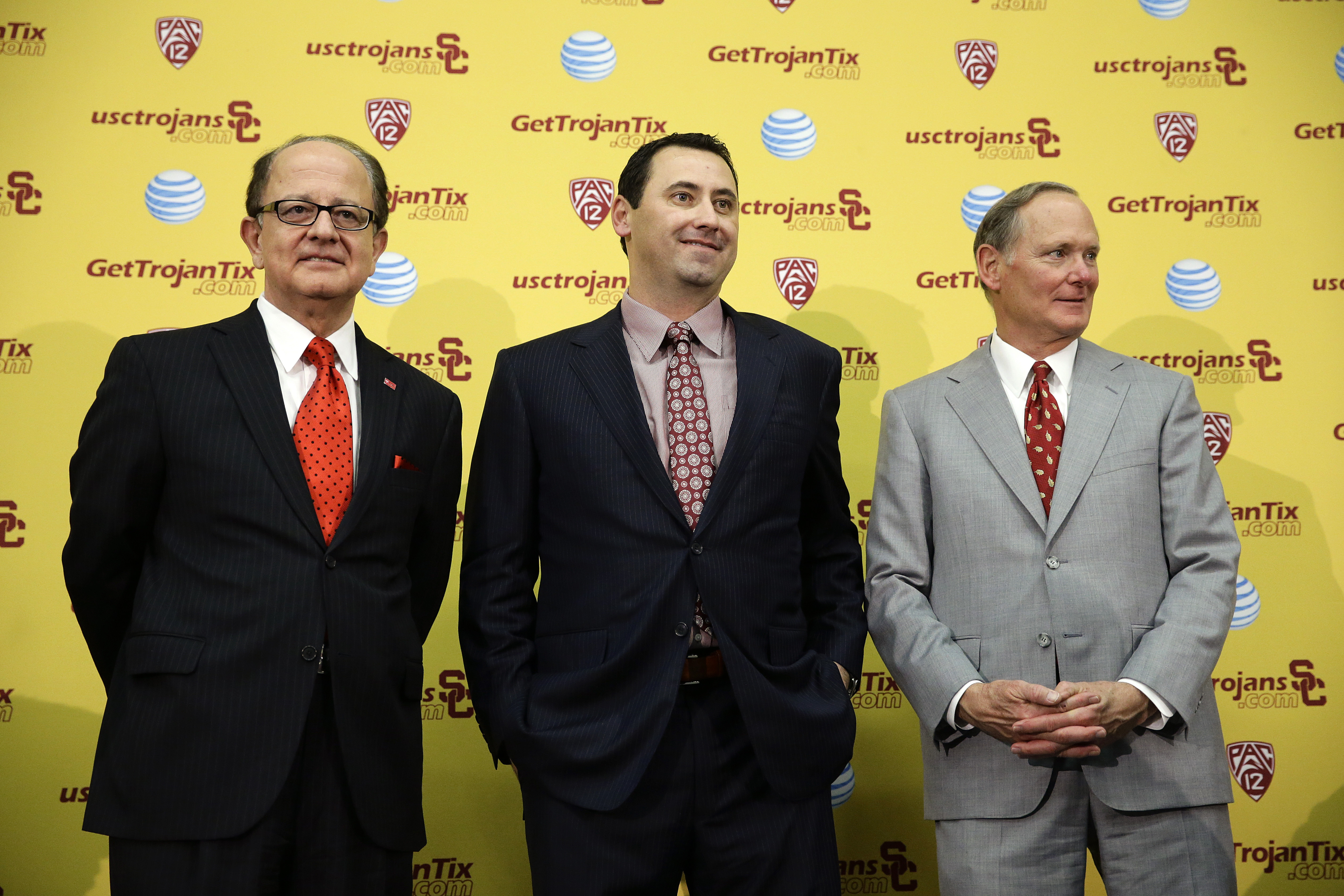 New Southern California football head coach Steve Sarkisian, center, stands with president C. L. Max Nikias, left, and athletic director Pat Haden for photos during a news conference on Tuesday, Dec. 3, 2013, in Los Angeles. USC hired Sarkisian away from Washington on Monday, bringing back the former Trojans offensive coordinator to his native Los Angeles area and the storied program where he thrived as Pete Carroll's assistant. (AP Photo/Jae C. Hong)
