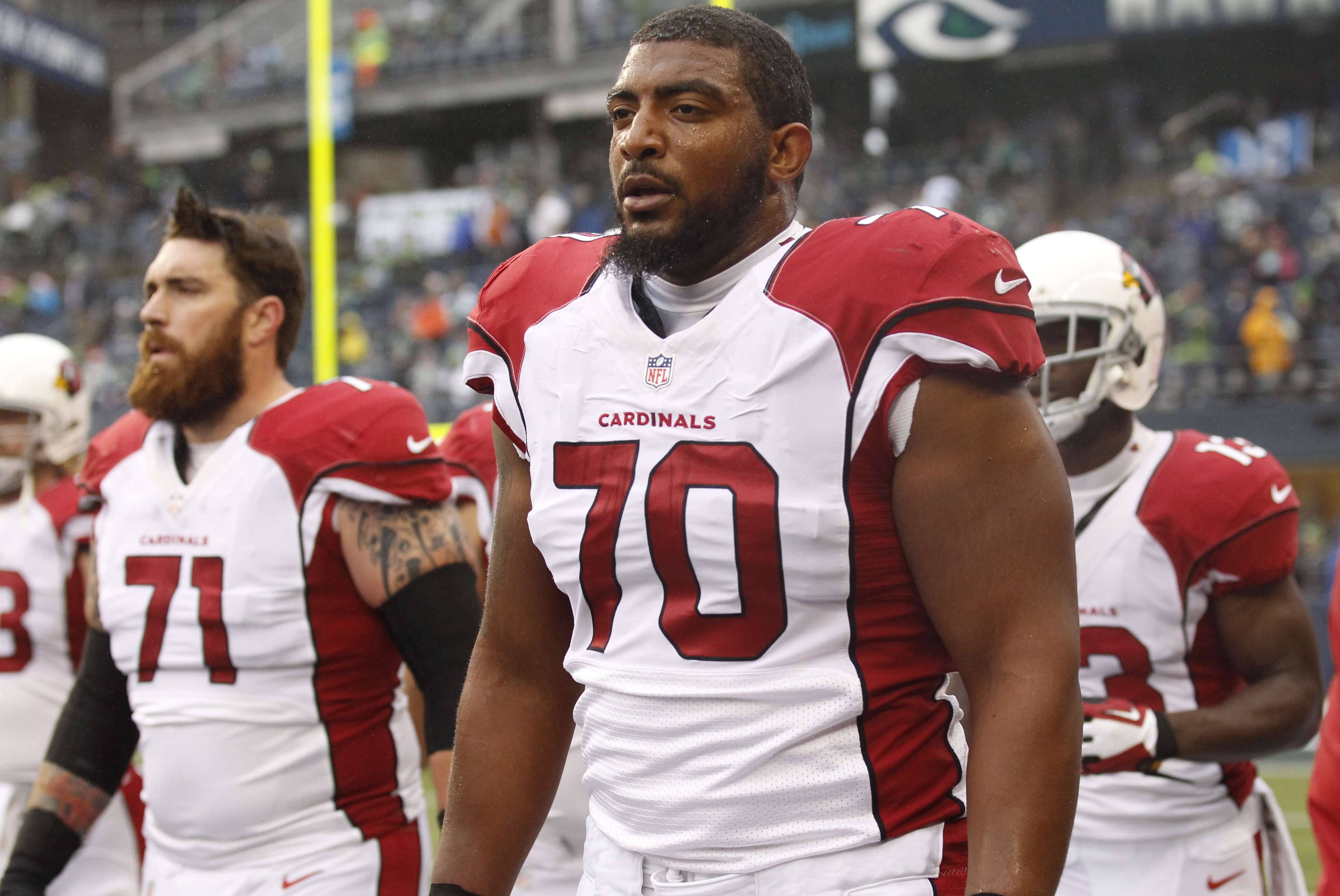 Arizona Cardinals tackle Bobby Massie (70) and guard Daryn Colledge walk off the field after warmups before an NFL football game against the Seattle Seahawks, Sunday, Dec. 22, 2013, in Seattle. (AP Photo/Stephen Brashear)