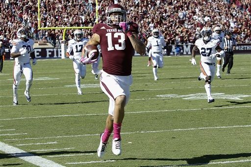 Texas A&M wide receiver Mike Evans (13) runs a 64-yard touchdown against Auburn in the first half during an NCAA college football game Saturday, Oct. 19, 2013, in College Station, Texas. (AP Photo/Bob Levey)