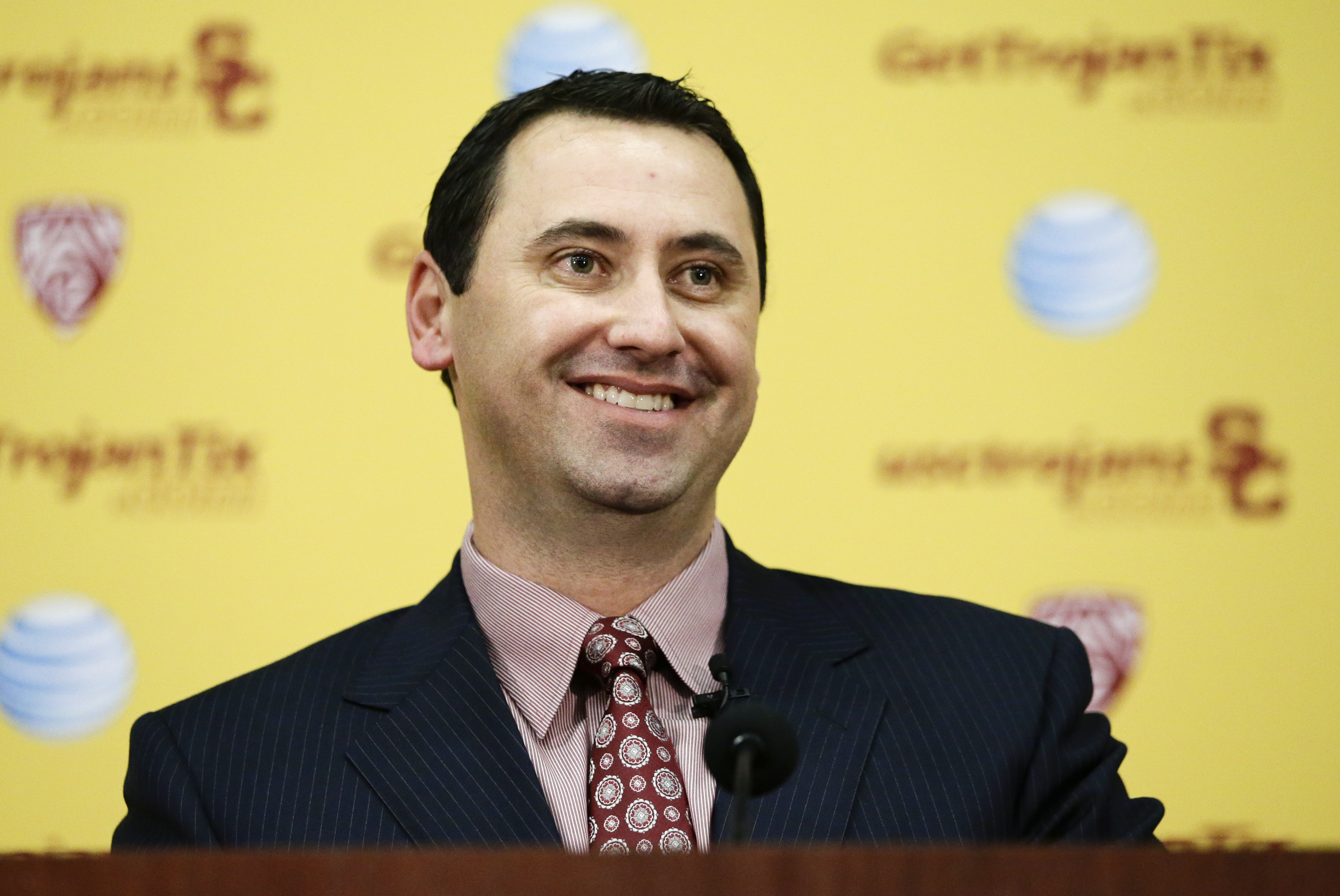 New Southern California football head coach Steve Sarkisian smiles during a news conference on Tuesday, Dec. 3, 2013, in Los Angeles. USC hired Sarkisian away from Washington on Monday, bringing back the former Trojans offensive coordinator to his native Los Angeles area and the storied program where he thrived as Pete Carroll's assistant. (AP Photo/Jae C. Hong)
