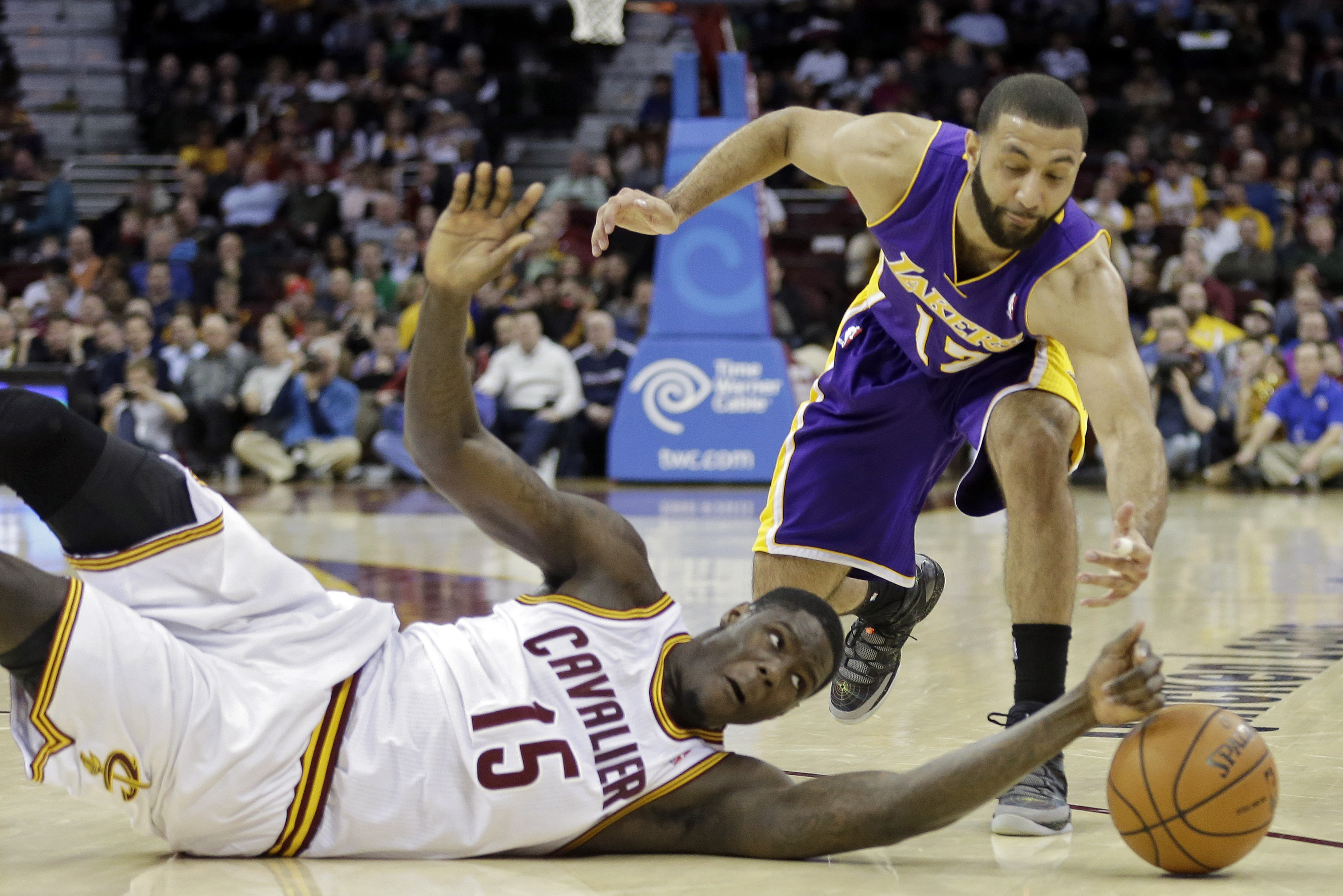 Cleveland Cavaliers' Anthony Bennett (15) bats a loose ball away from Los Angeles Lakers' Kendall Marshall in the fourth quarter of an NBA basketball game on Wednesday, Feb. 5, 2014, in Cleveland. The Lakers won 119-108. (AP Photo/Mark Duncan)