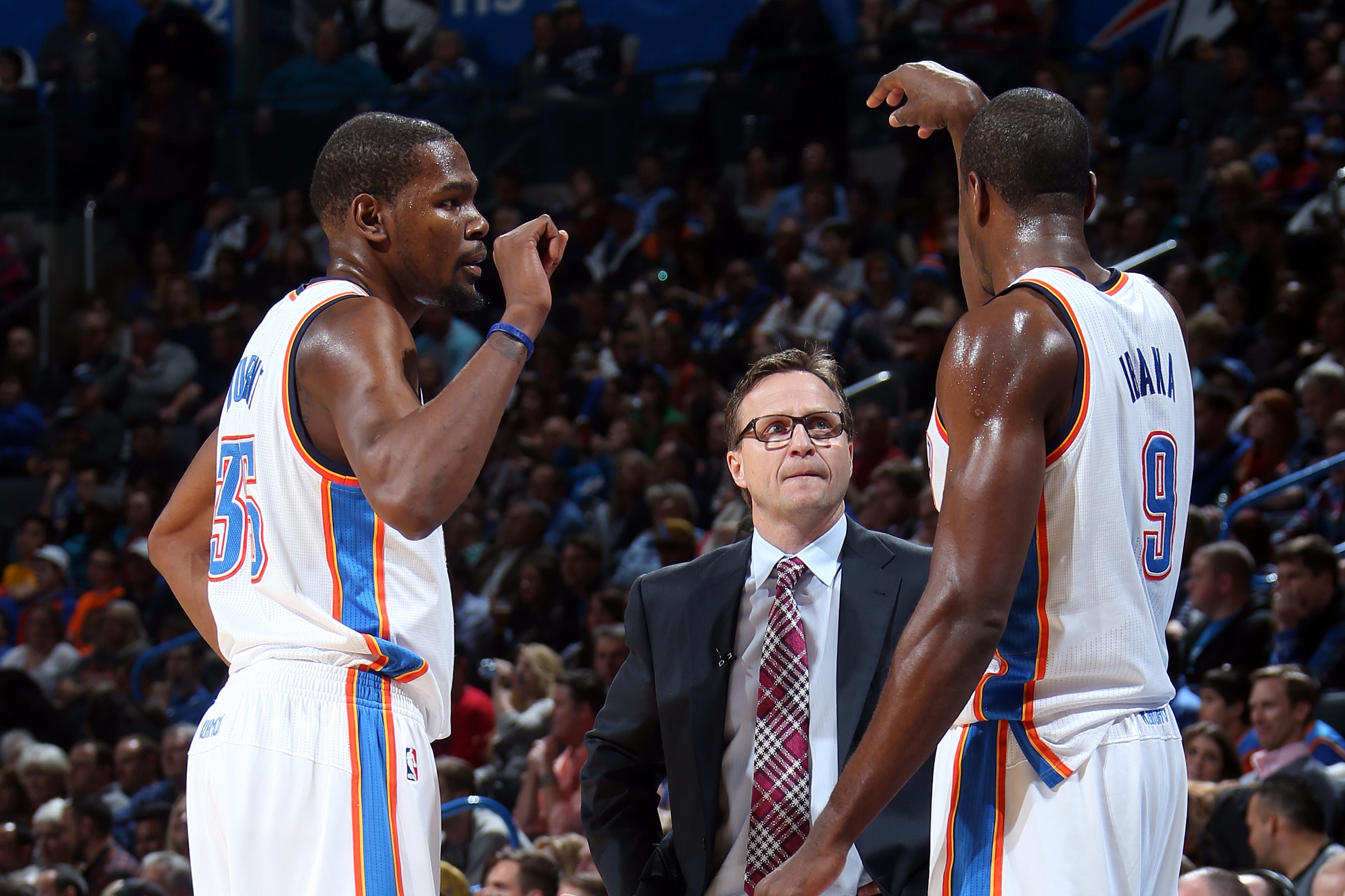 OKLAHOMA CITY, OK - JANUARY 17: Kevin Durant #35 of the Oklahoma City Thunder, Serge Ibaka #9 of the Oklahoma City Thunder, and Scott Brooks, head coach of the Oklahoma City Thunder during an NBA game on January 17, 2014 at the Chesapeake Energy Arena in Oklahoma City, Oklahoma. NOTE TO USER: User expressly acknowledges and agrees that, by downloading and or using this Photograph, user is consenting to the terms and conditions of the Getty Images License Agreement. Mandatory Copyright Notice: Copyright 2014 NBAE (Photo by Layne Murdoch/NBAE via Getty Images)