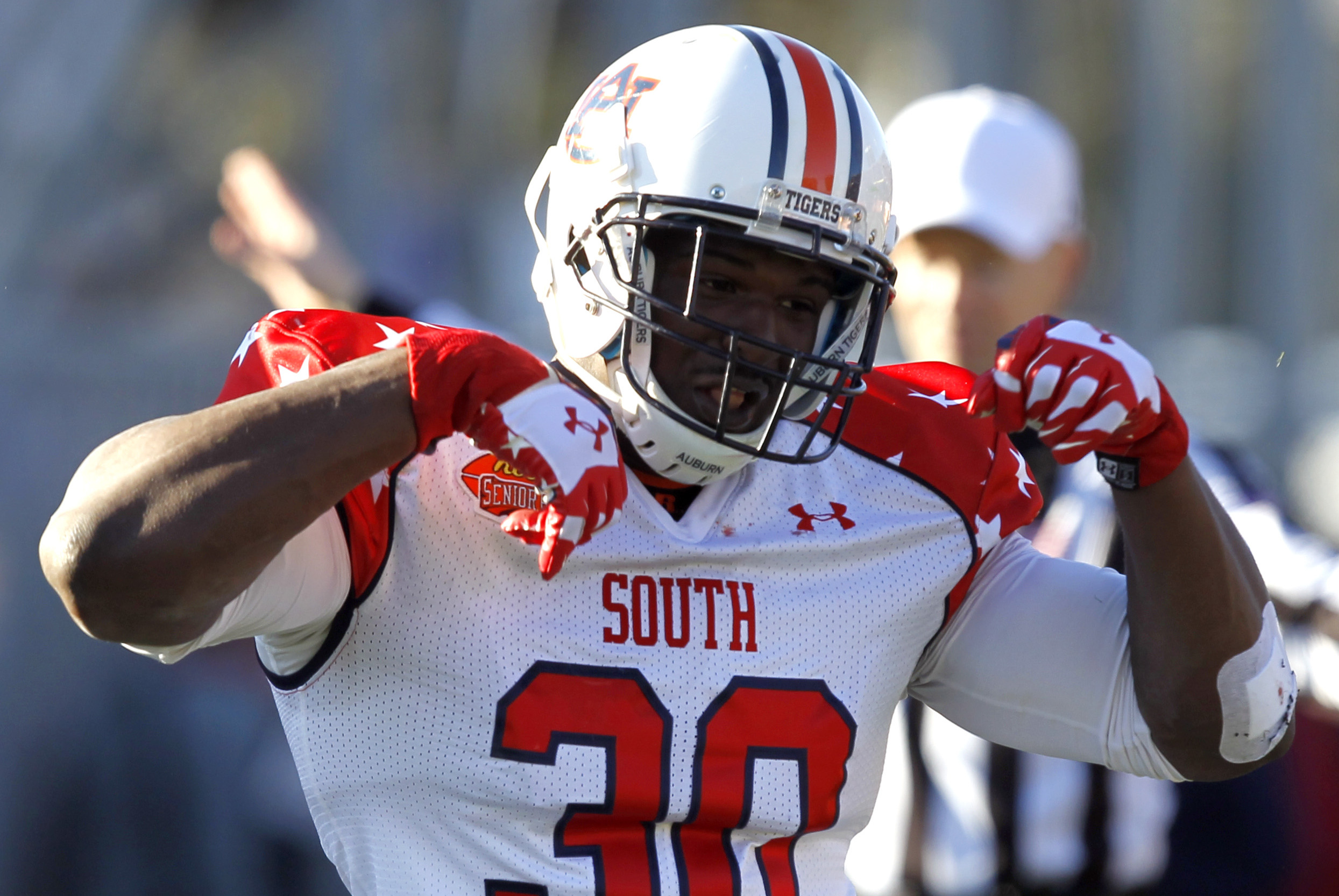 South defensive end Dee Ford (30), of Auburn, celebrates after a sack of the North quarterback during the first half of the Senior Bowl NCAA college football game on Saturday, Jan. 25, 2014, in Mobile, Ala. (AP Photo/Butch Dill)