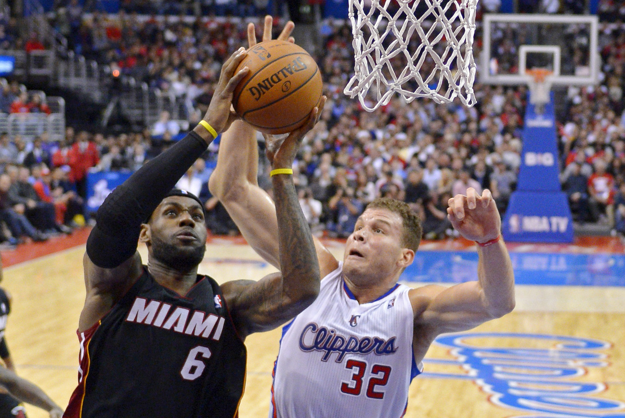 Miami Heat forward LeBron James, left, puts up a shot as Los Angeles Clippers forward Blake Griffin defends during the first half of an NBA basketball game, Wednesday, Feb. 5, 2014, in Los Angeles. (AP Photo/Mark J. Terrill)