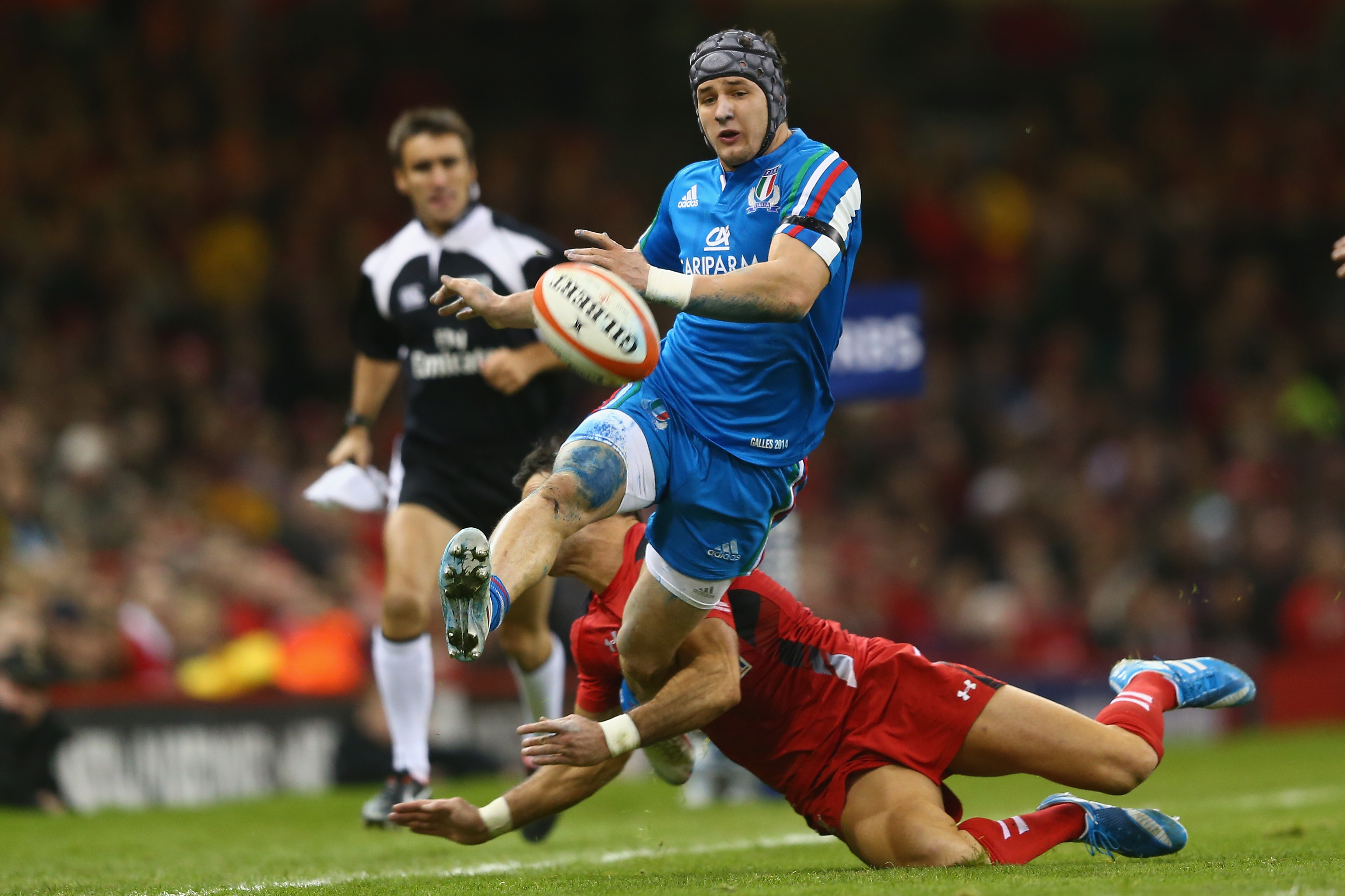 CARDIFF, WALES - FEBRUARY 01:  Michele Campagnaro of Italy kicks ahead as Mike Phillips of Wales tackles during the RBS Six Nations match between Wales and Italy at the Millenium Stadium on February 1, 2014 in Cardiff, Wales.  (Photo by Michael Steele/Getty Images)