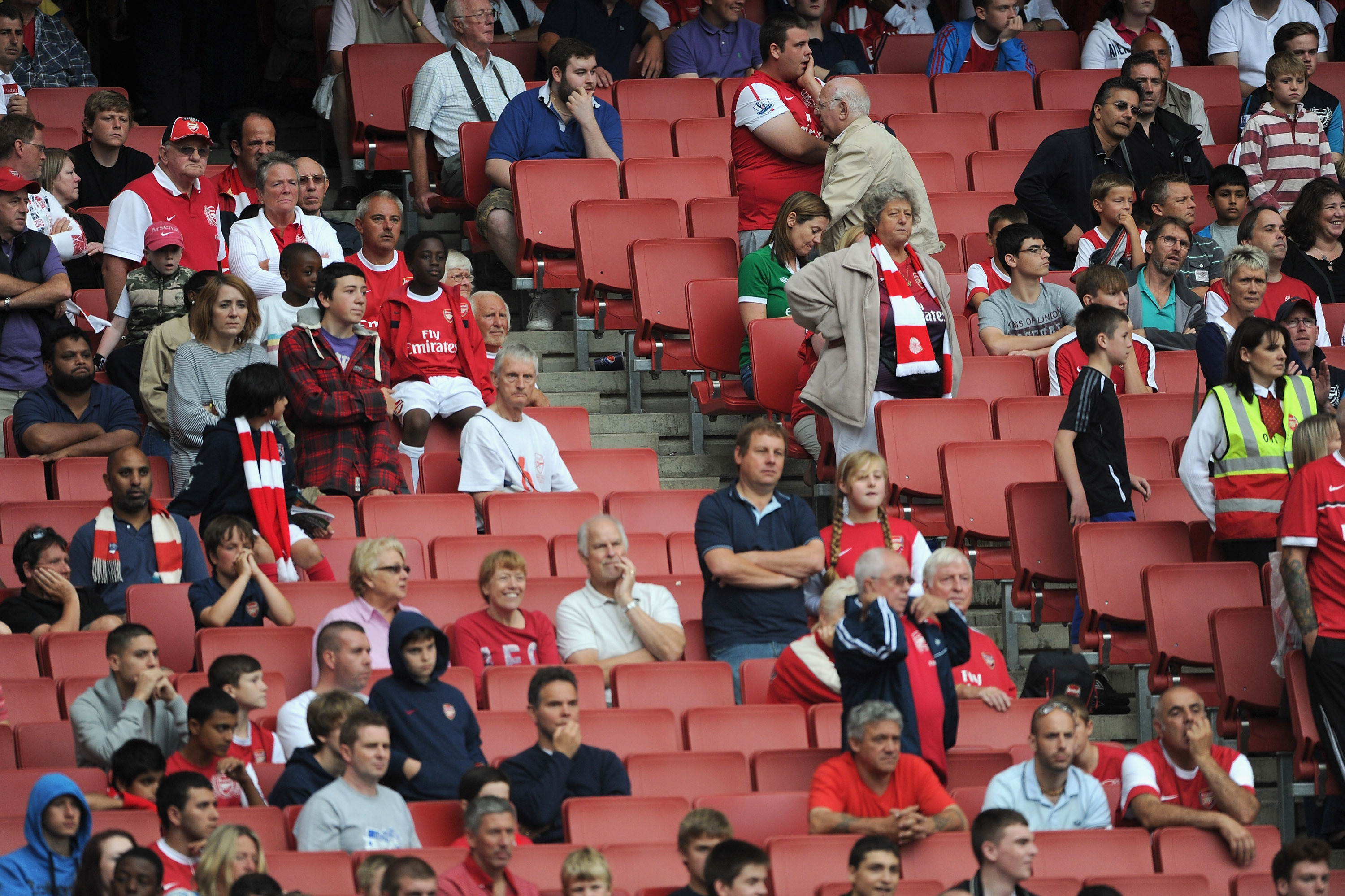 LONDON, ENGLAND - AUGUST 20:  Dejected Arsenal fans and empty seats during defeat in the Barclays Premier League match between Arsenal and Liverpool at the Emirates Stadium on August 20, 2011 in London, England.  (Photo by Michael Regan/Getty Images)